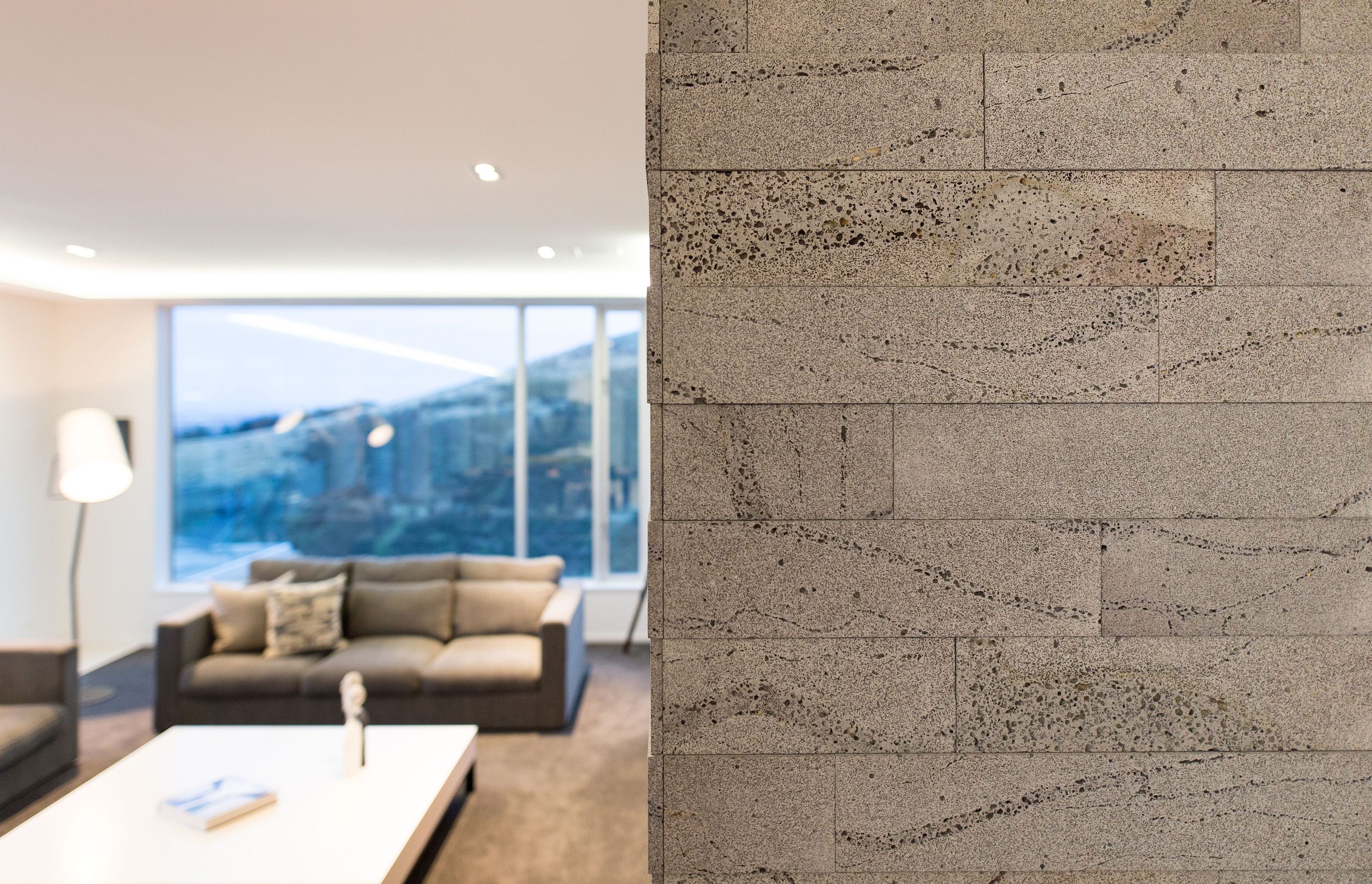 Timaru bluestone in two different depths has been used to clad the fireplace, again mimicking the board-formed concrete exterior.