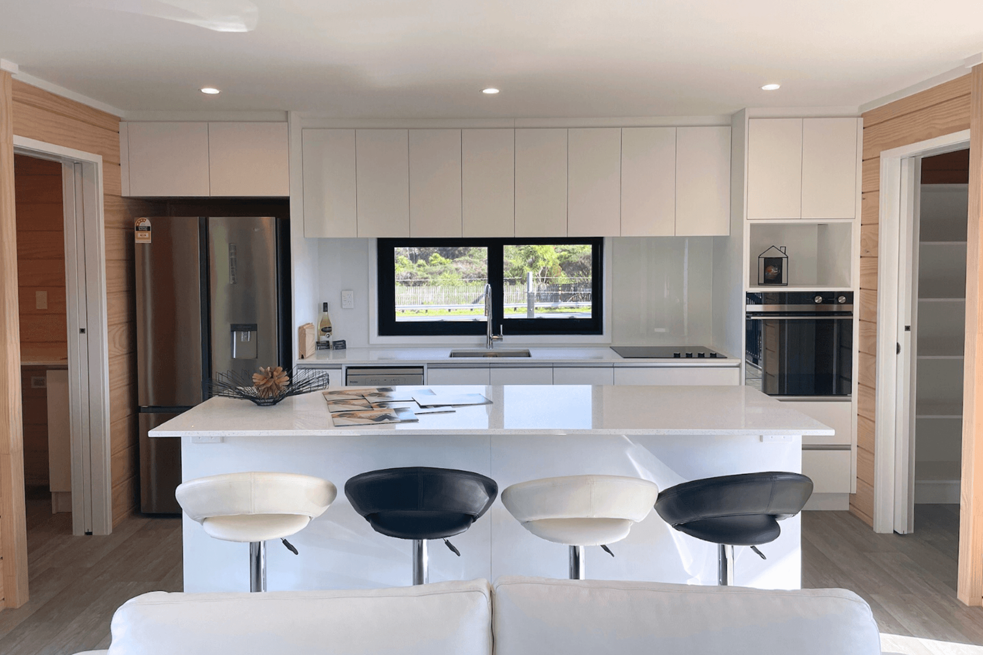 Thoughtfully Designed Kitchen and adjacent laundry (left) & pantry (right)