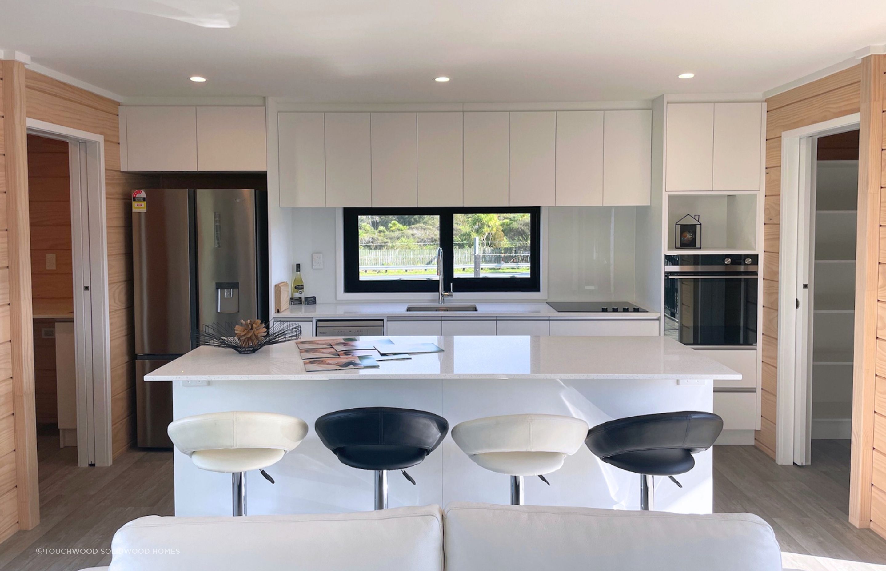 Thoughtfully Designed Kitchen and adjacent laundry (left) &amp; pantry (right)