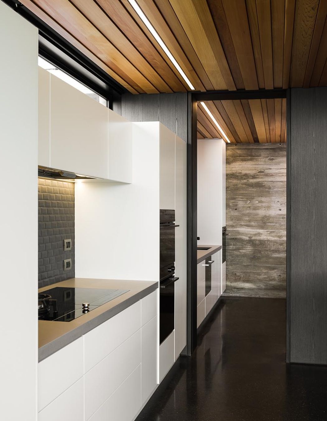 The simplicity of the kitchen mimics the overall simplicity of the building's design.