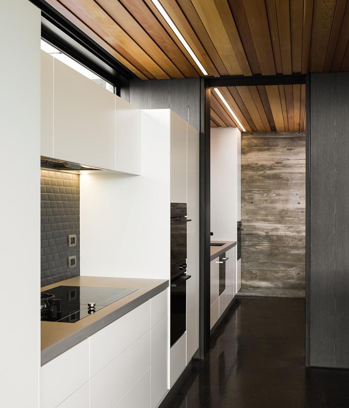 The simplicity of the kitchen mimics the overall simplicity of the building's design.