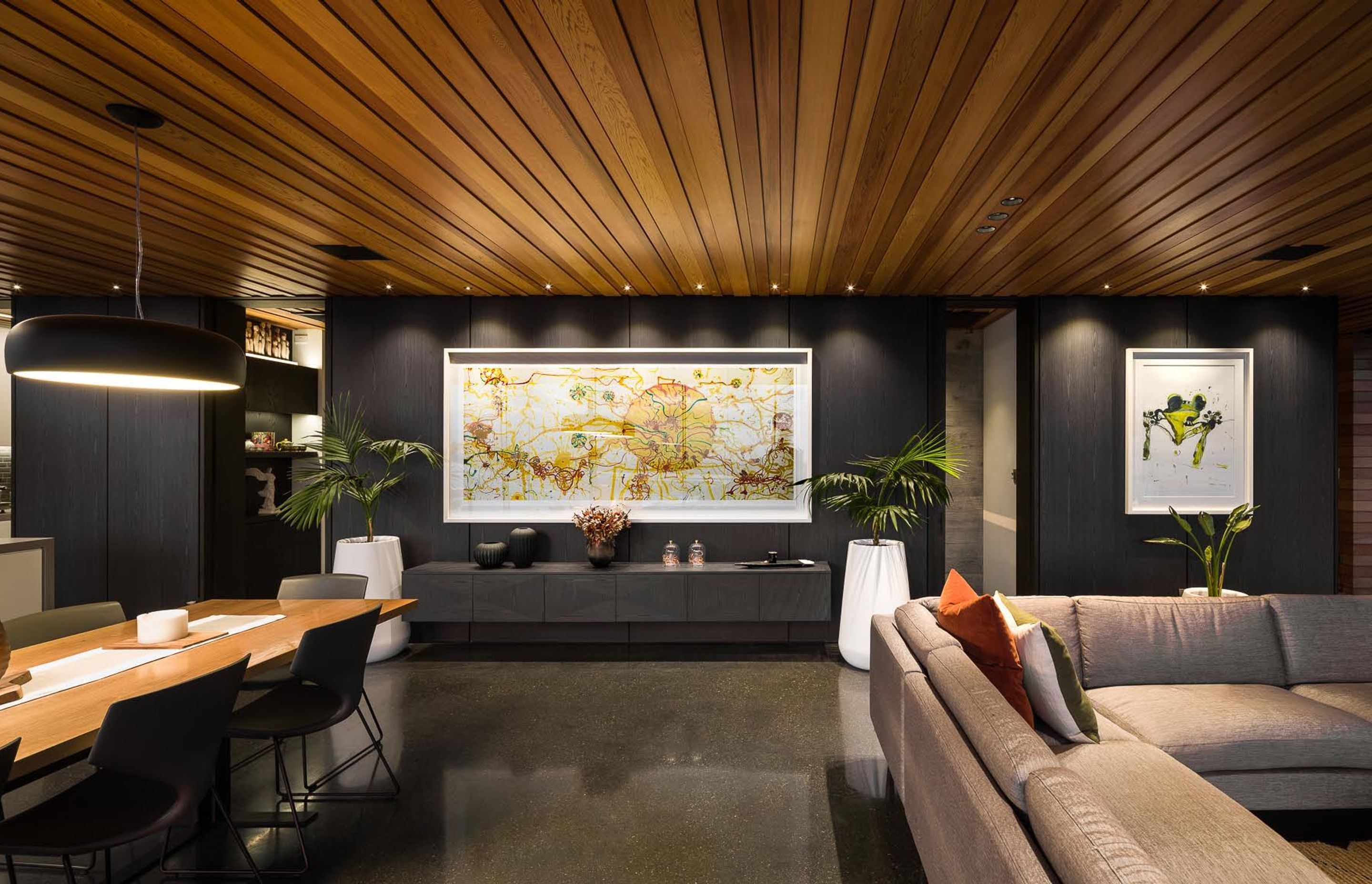 The warm timber ceiling panels juxtapose with the surrounding materials.
