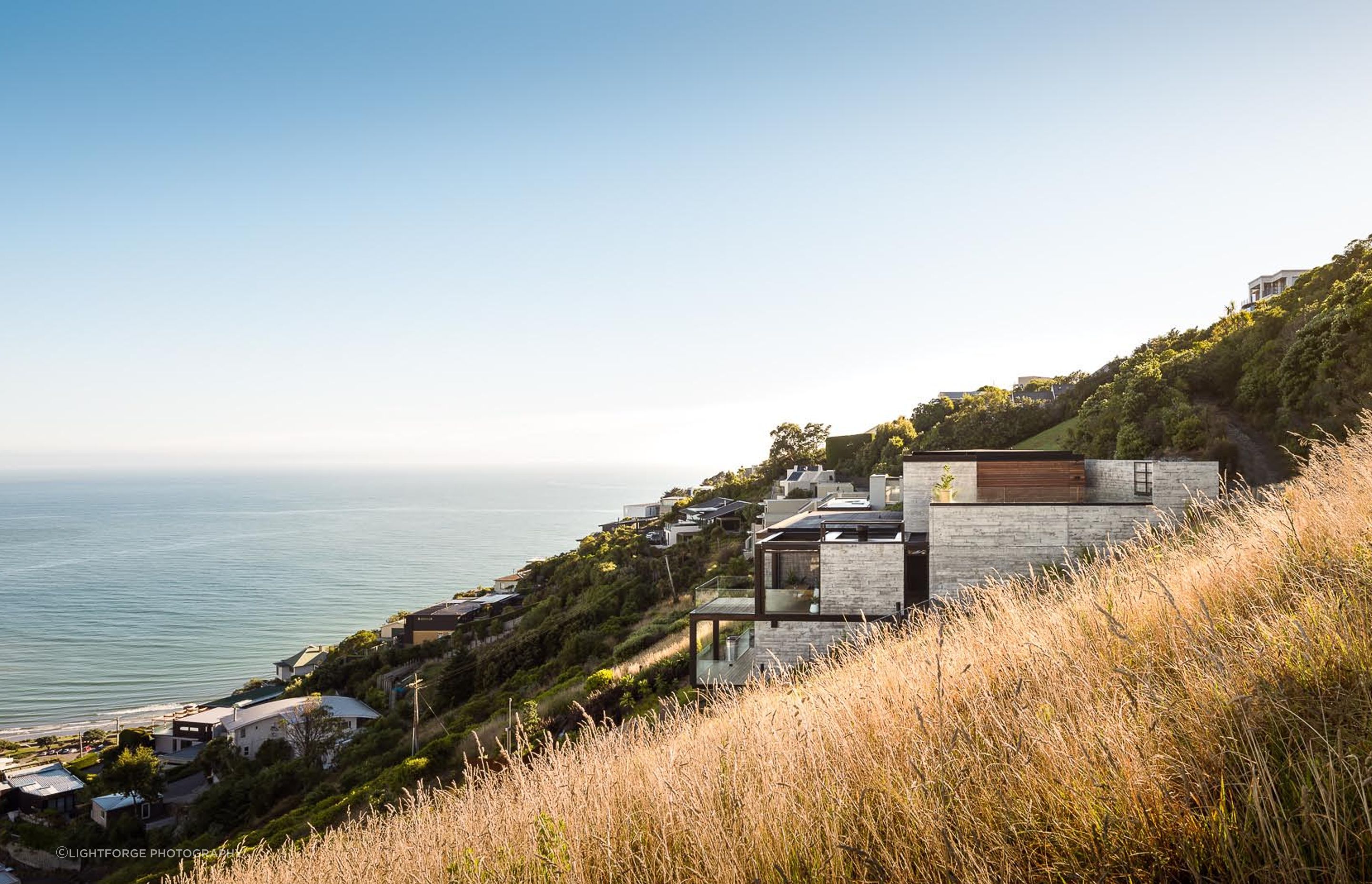 The structure emerges from the landscape in cubed forms.