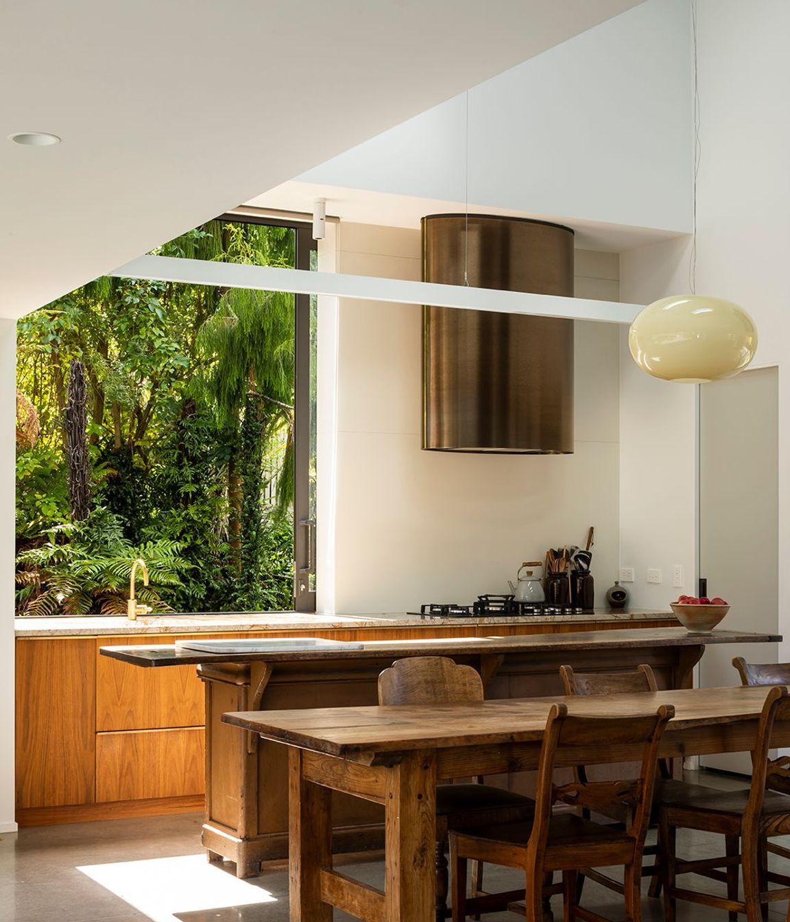 The large sliding kitchen window gives a jaw-dropping picture view to the native bush reserve.