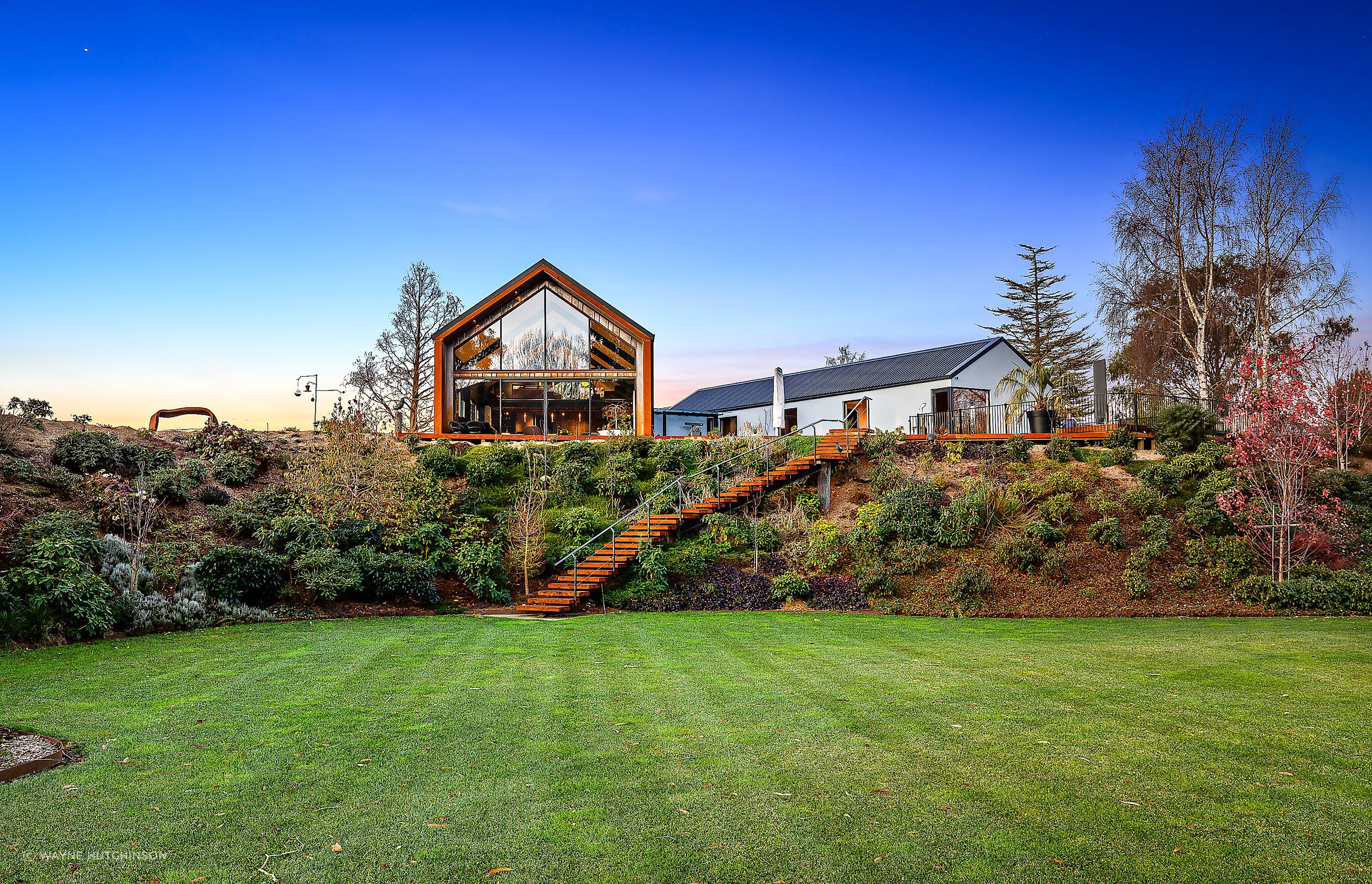 The home overlooks the established gardens on the property.