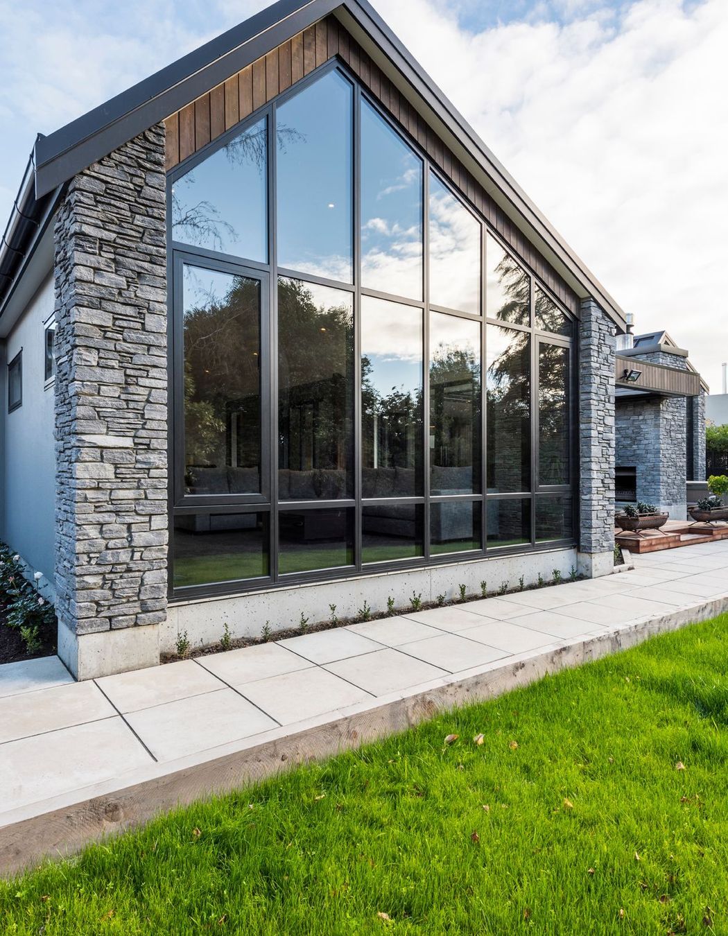 A wall of glazing highlights the asymmetrical angle of the livings space.