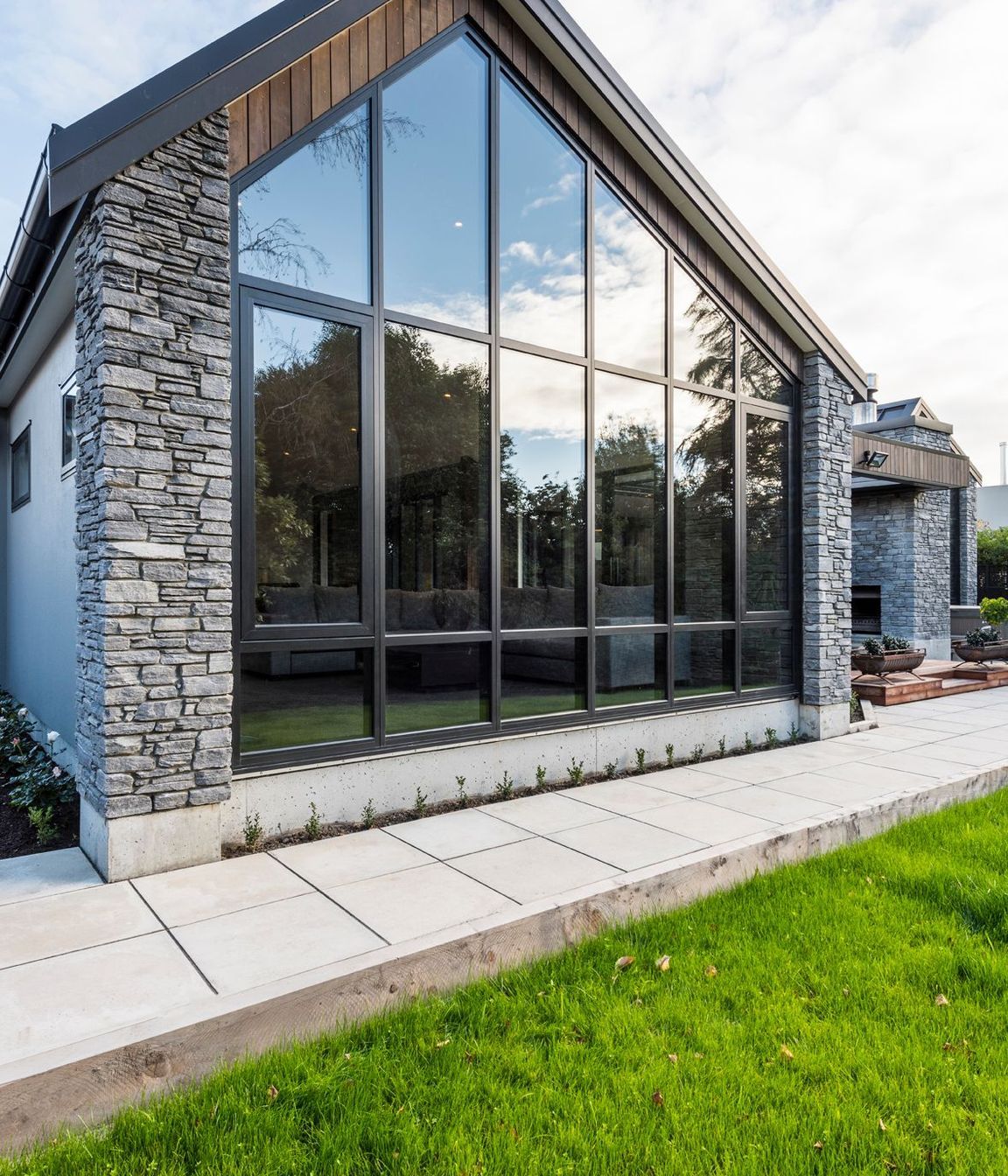 A wall of glazing highlights the asymmetrical angle of the livings space.