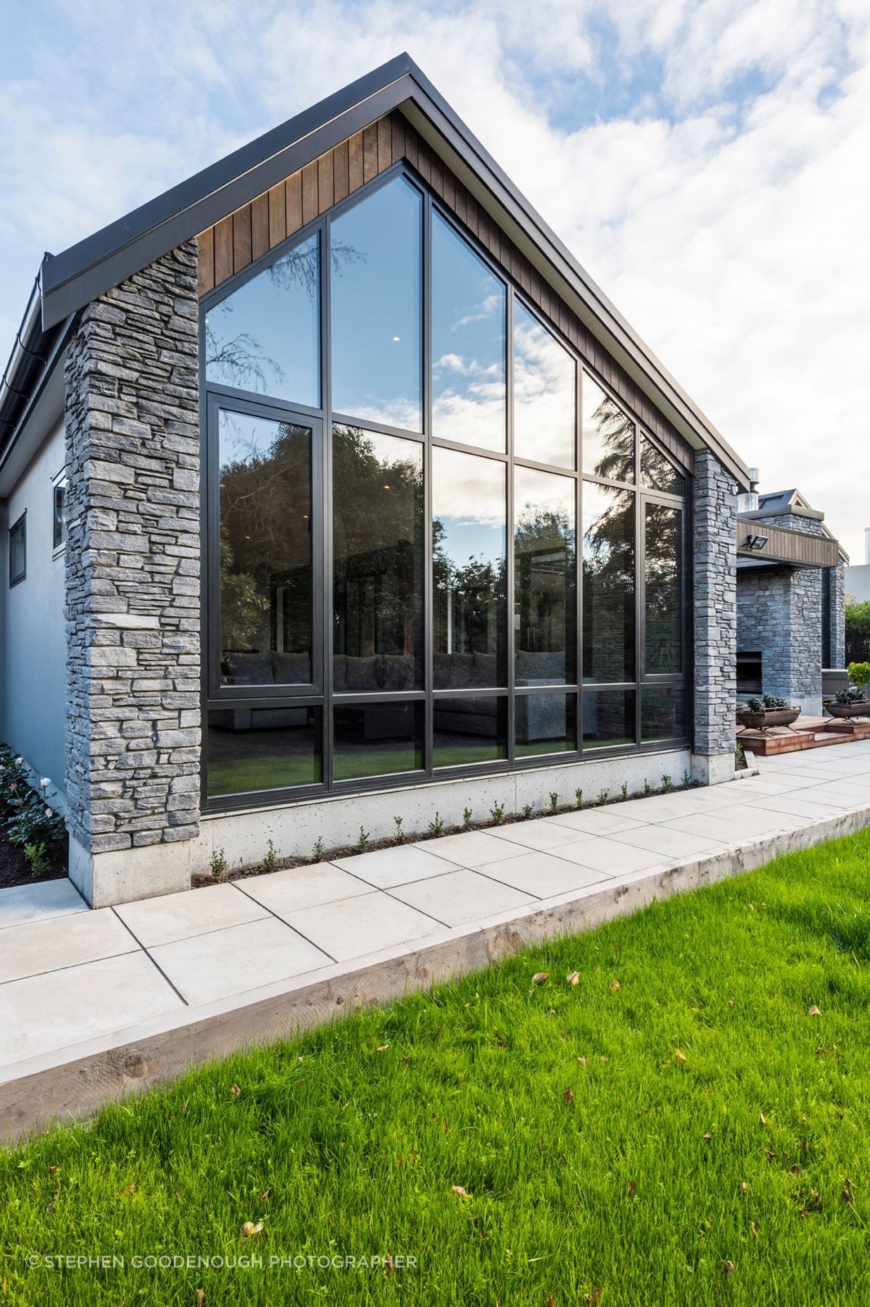 A wall of glazing highlights the asymmetrical angle of the livings space.