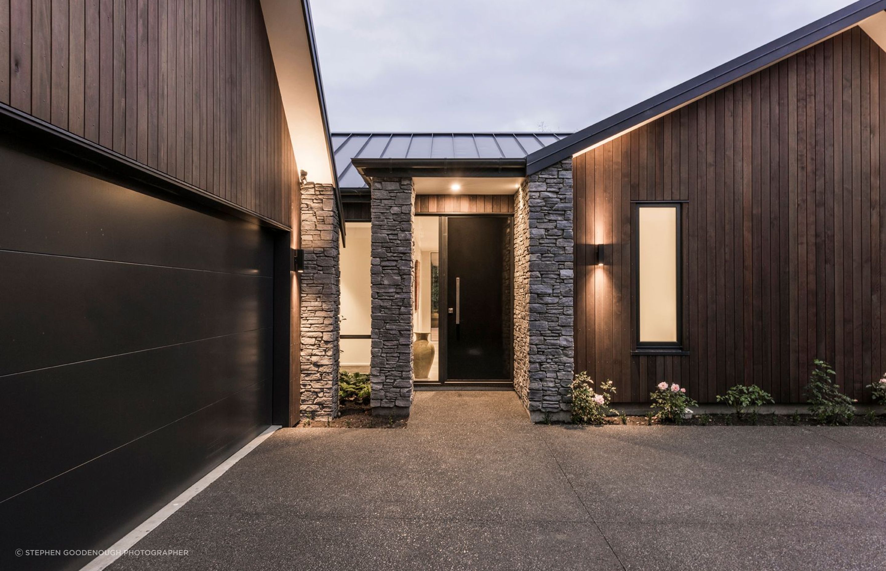 The client requested a luxury material palette including stone, cedar and tray profile roofing.