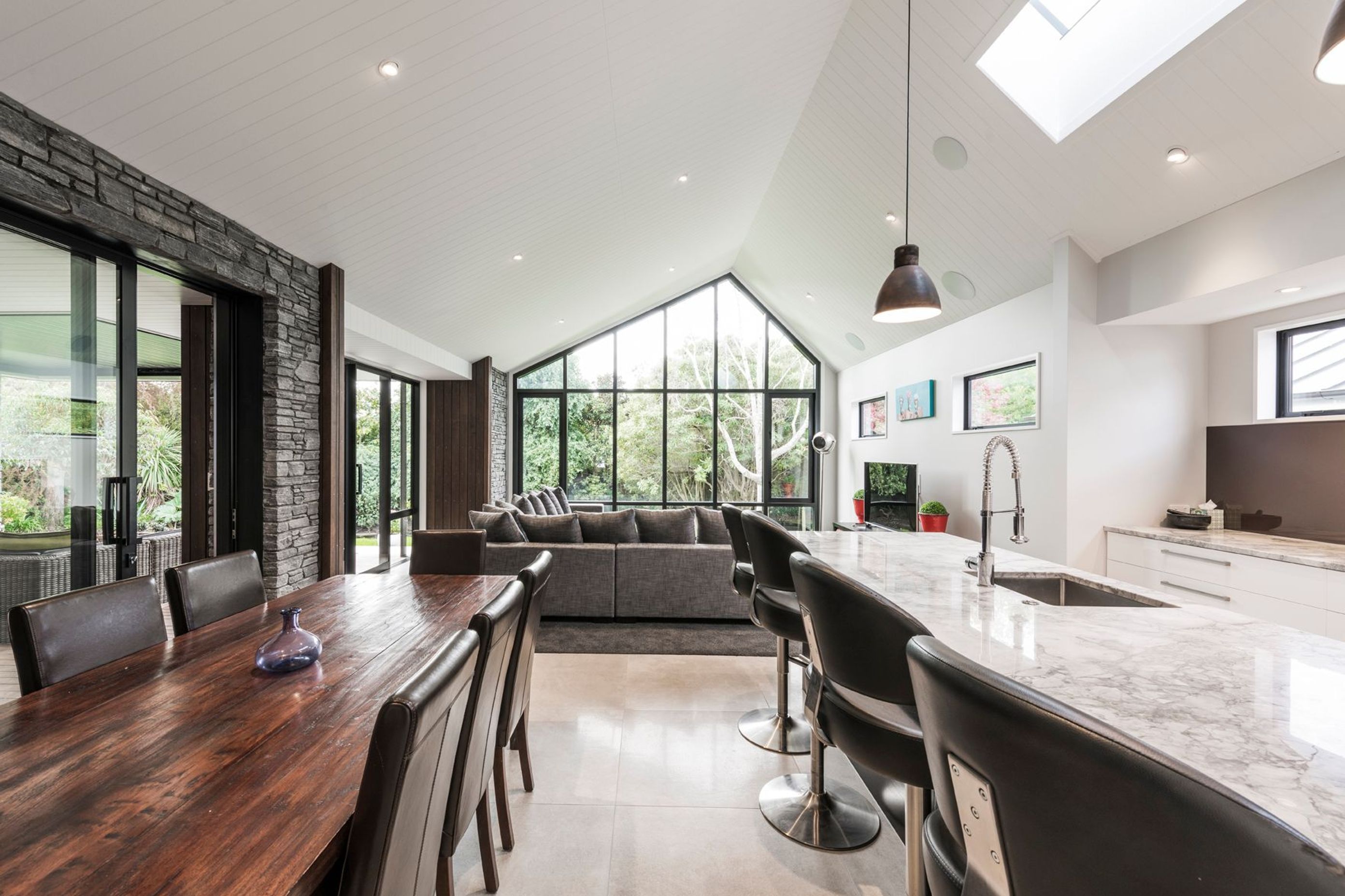 Through opening the sliders between the kitchen/dining space and the lounge to the left, and covered outdoor room, a large seamless space can be created when entertaining large groups.