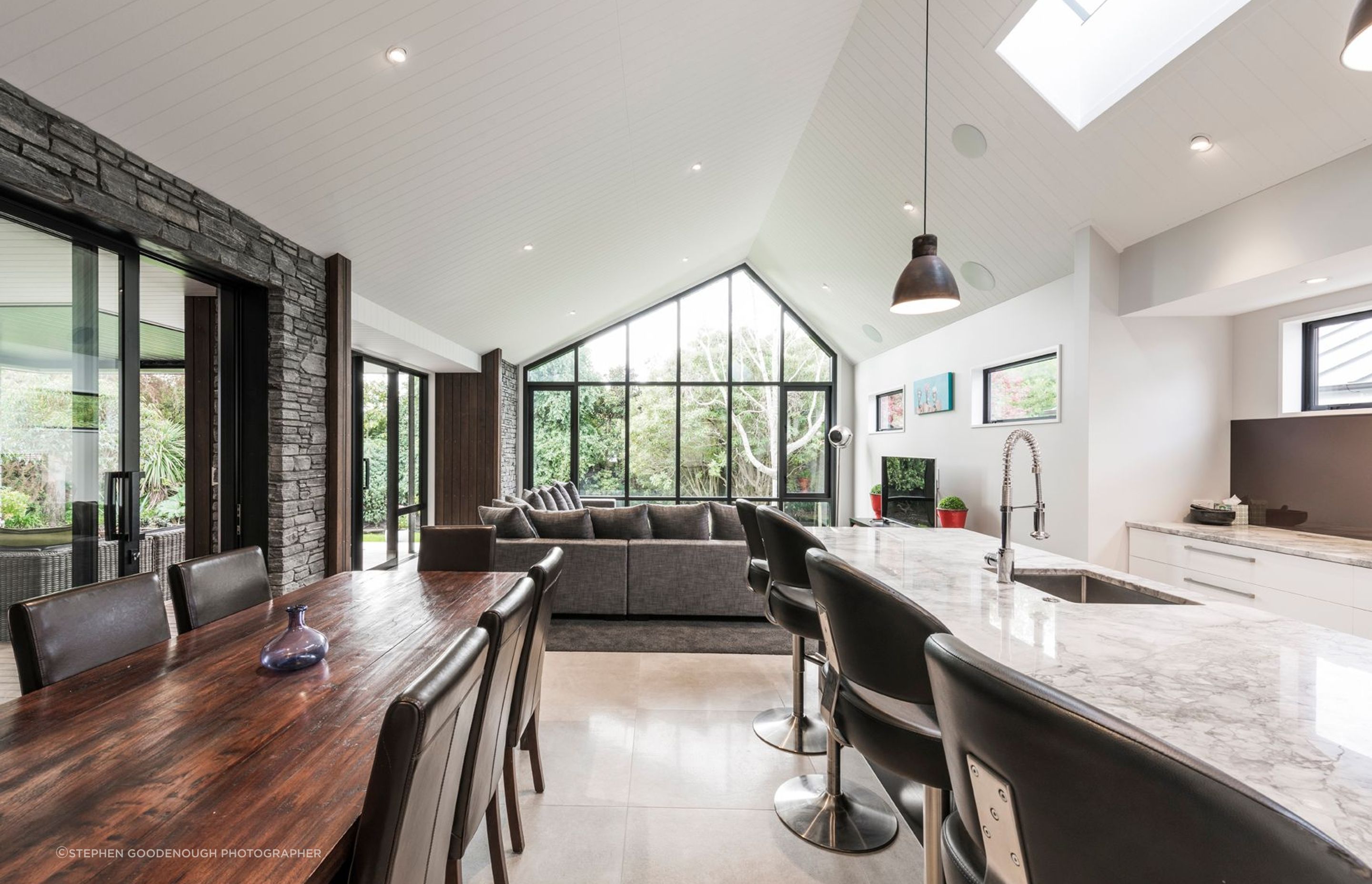 Through opening the sliders between the kitchen/dining space and the lounge to the left, and covered outdoor room, a large seamless space can be created when entertaining large groups.