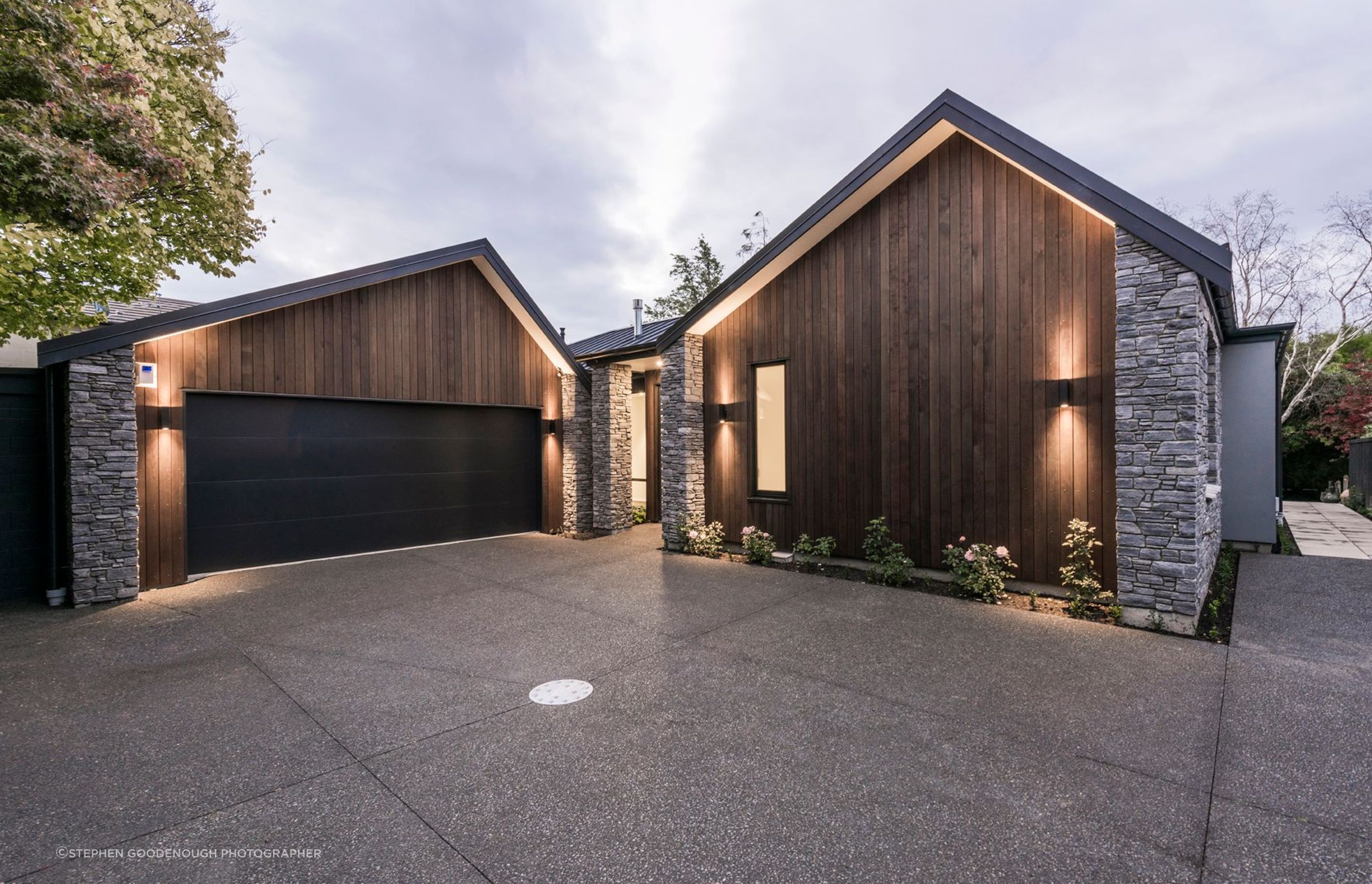 The face of the home seen in the forecourt, belies the idyllic stream setting.