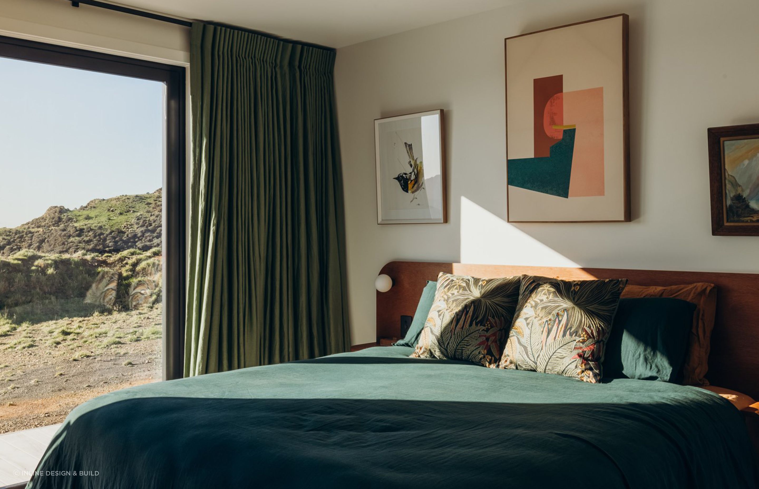 The Master Bedroom, with views over the Cook Strait, boasts a custom bed unit built by INLINE to compliment the cabinetry throughout the home.