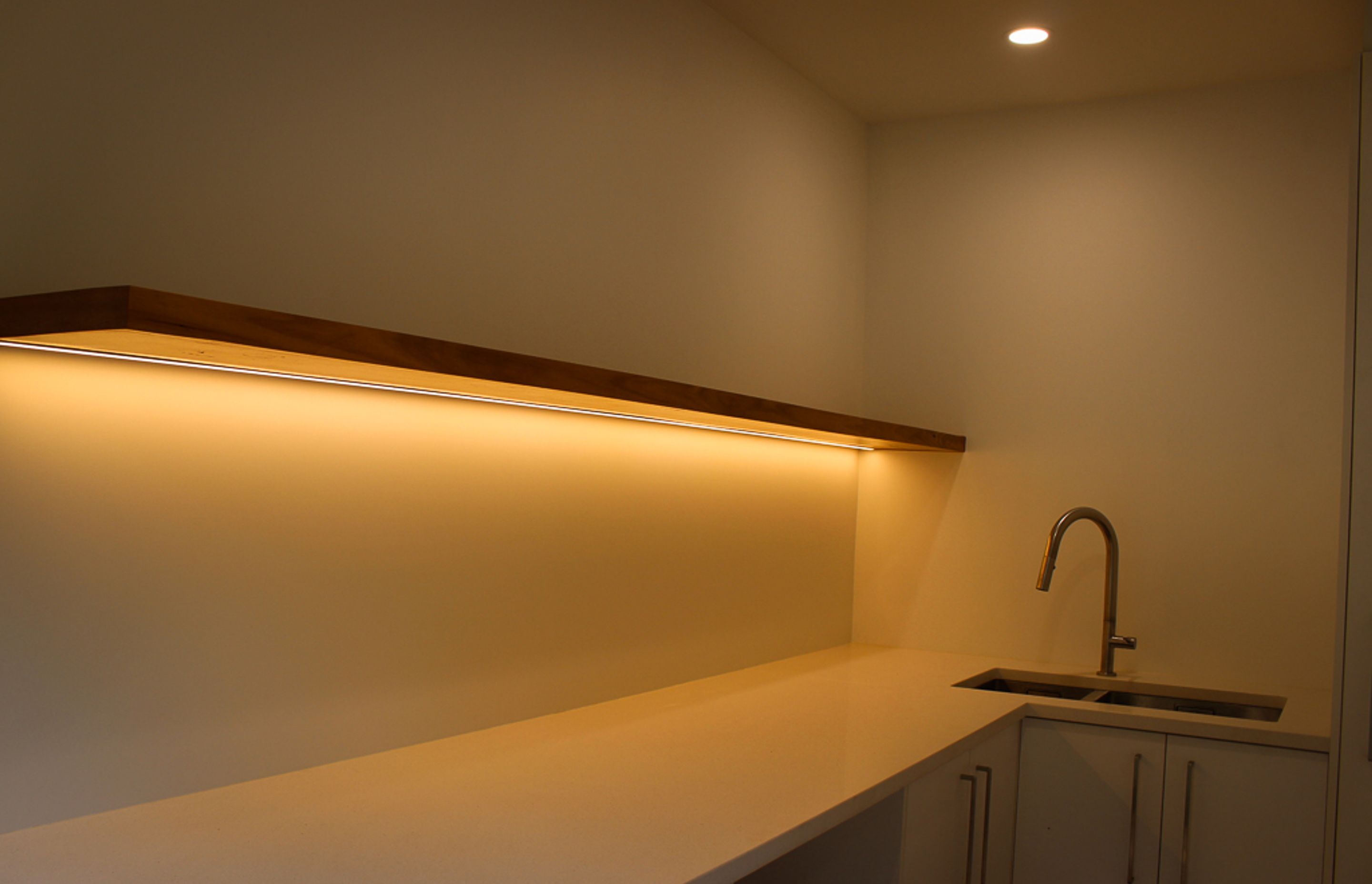 Blackbutt (Pilularis) timber custom built floating shelf give this functional laundry a high-end & luxurious feel. Inset strip LED lighting helps make this a really practical work area.