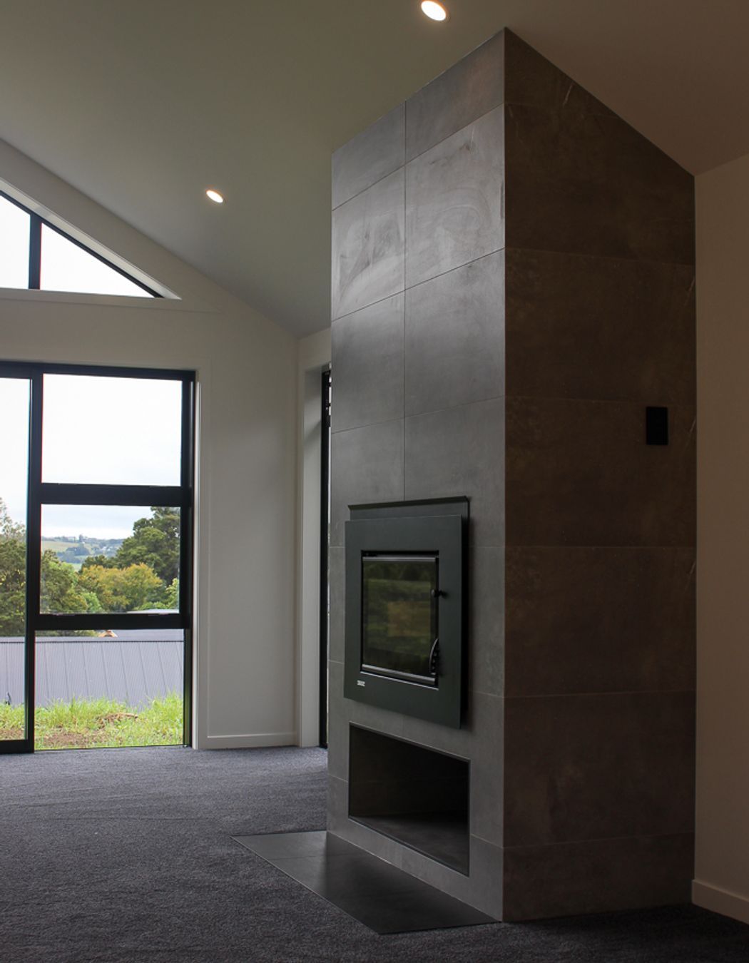 The tiled fireplace features a contemporary tiled firebox
