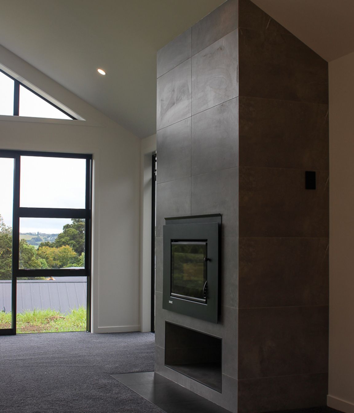 The tiled fireplace features a contemporary tiled firebox