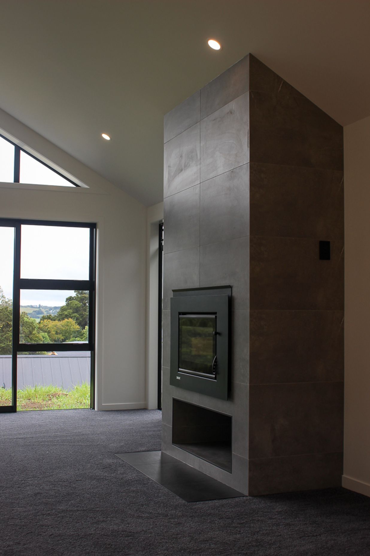 The tiled fireplace features a contemporary tiled firebox