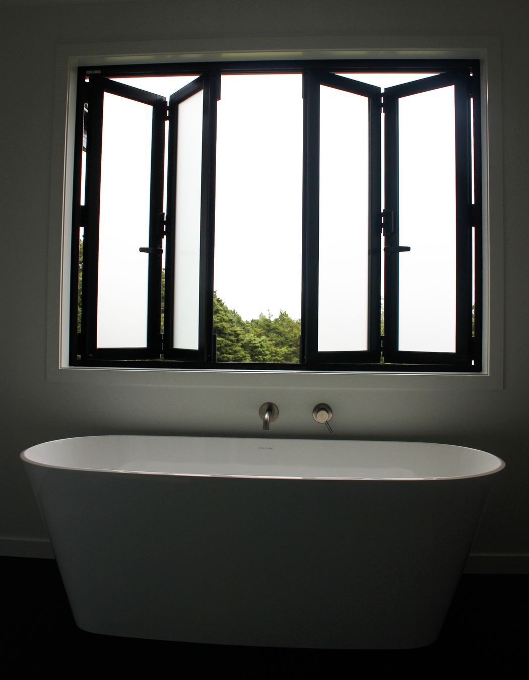 Bi-Folding joinery to make the most of this luxurious freestanding bath in the family bathroom