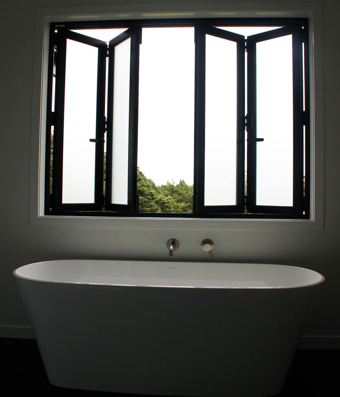 Bi-Folding joinery to make the most of this luxurious freestanding bath in the family bathroom