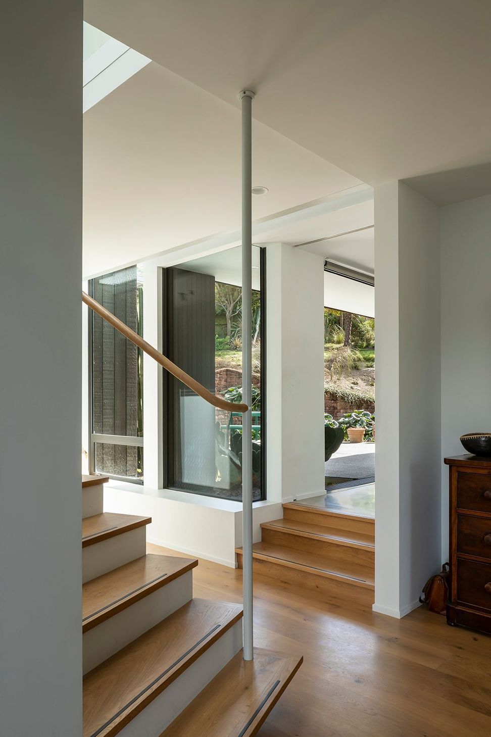 The stair has a a certain playful artistry, with the newell post connected to the beam above, which leaves the last five or six risers 'floating'.