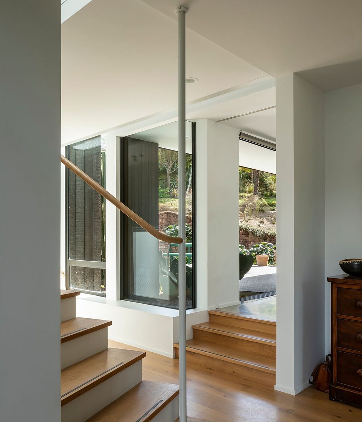 The stair has a a certain playful artistry, with the newell post connected to the beam above, which leaves the last five or six risers 'floating'.