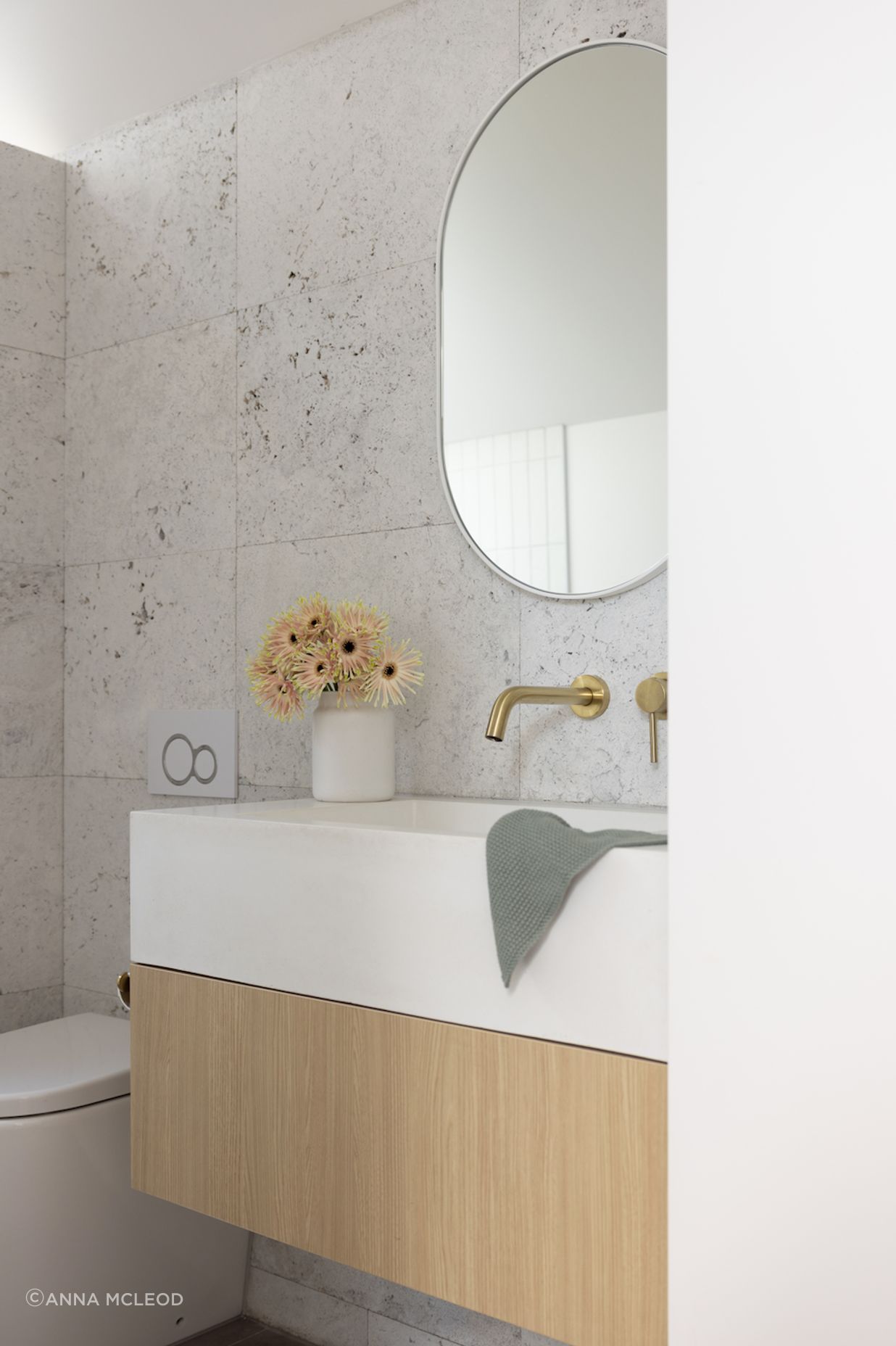 Silver travertine tiles from Artedomus and RAW Concrete basin