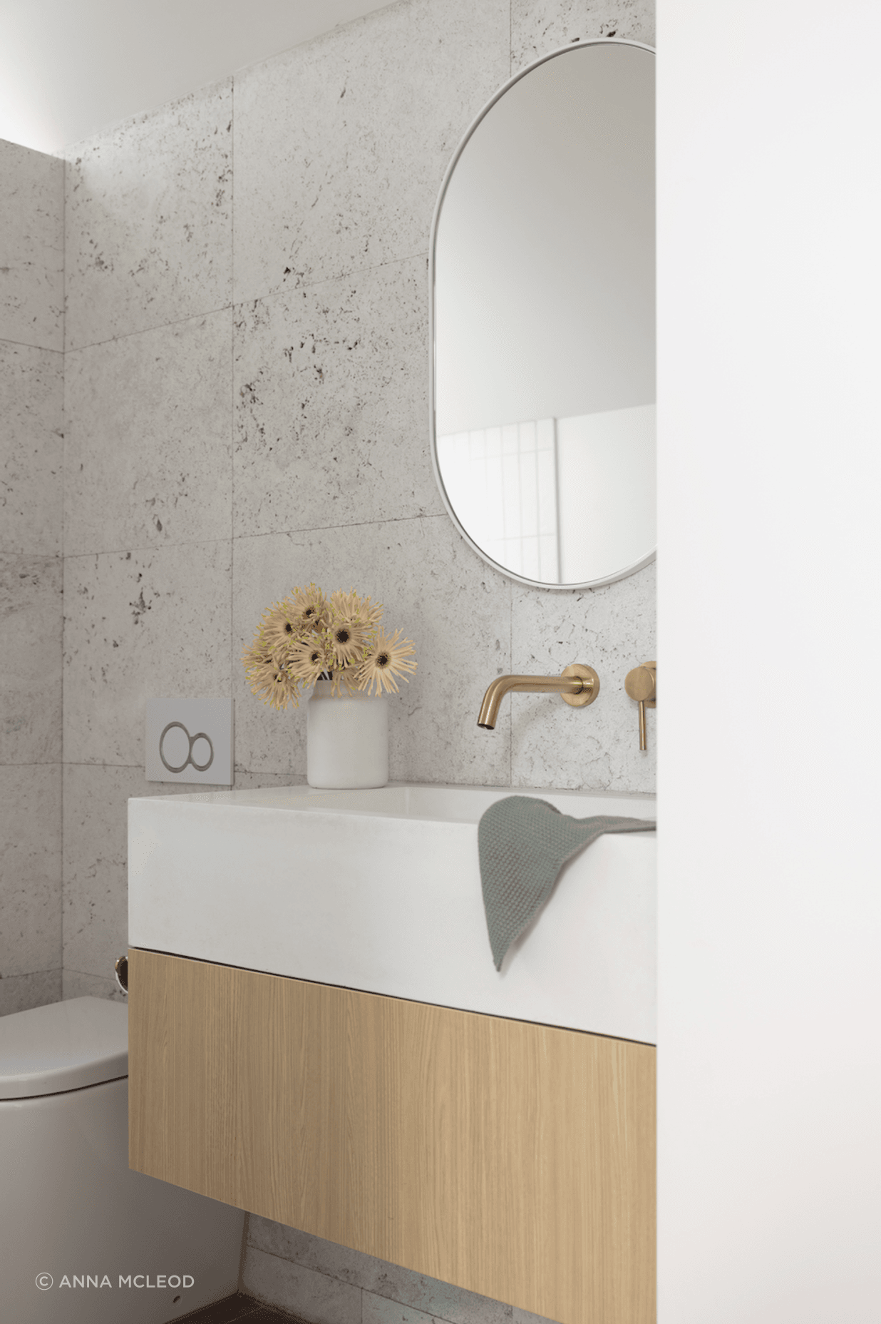 Silver travertine tiles from Artedomus and RAW Concrete basin