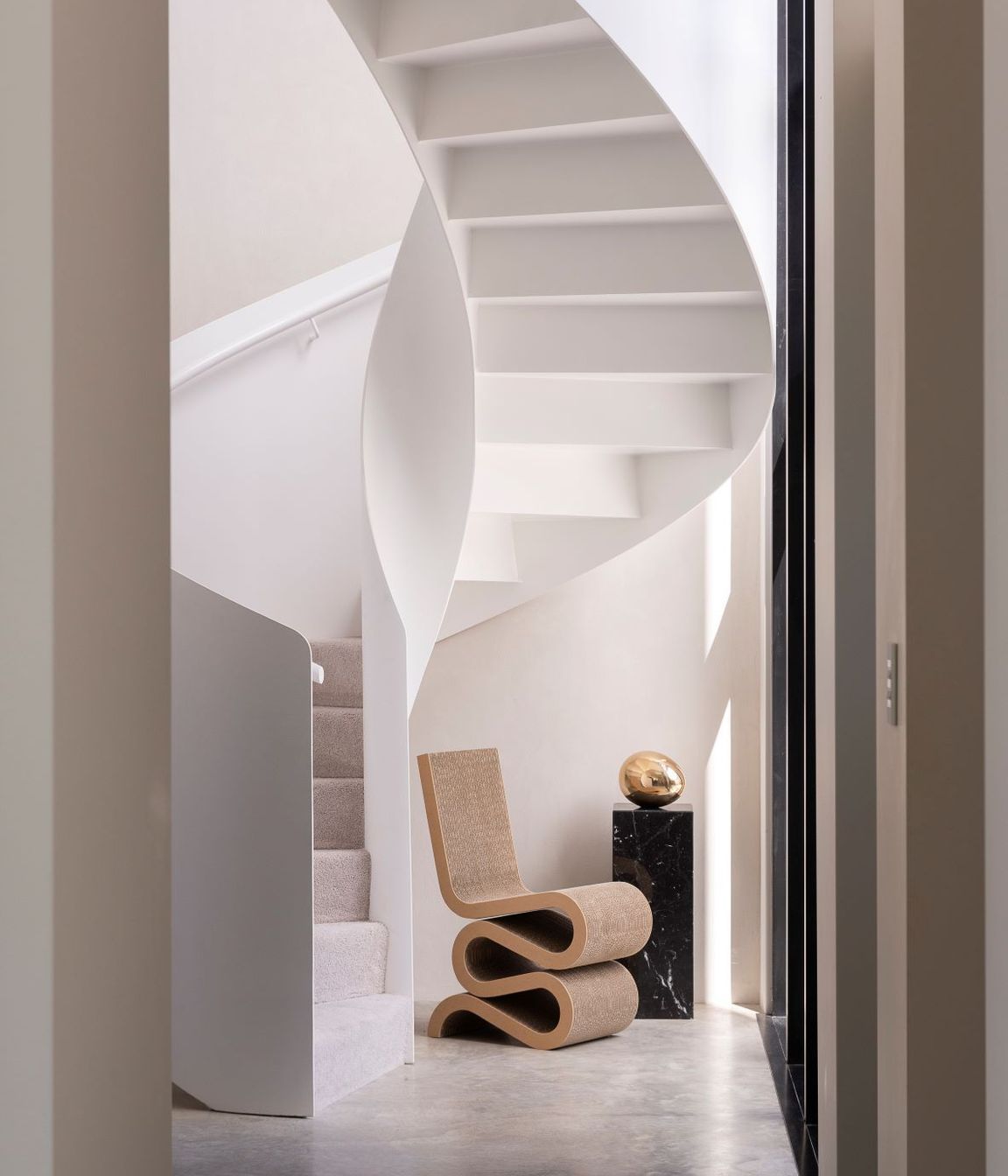 The spiral staircase, made from steel, commands attention in the entrance way.