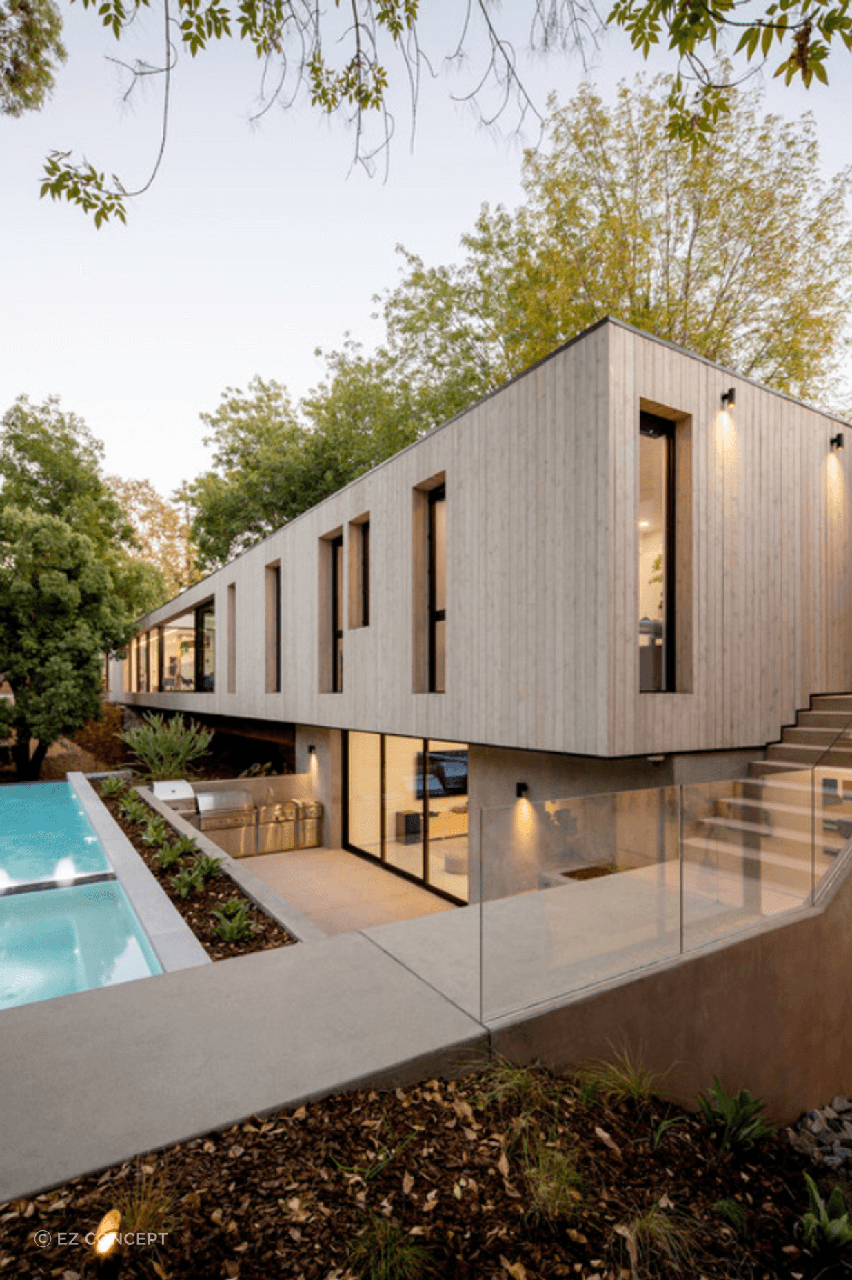 The exterior matches the minimalist aesthetic of the interior design - seen in the square-set timber façade and backyard pool area.