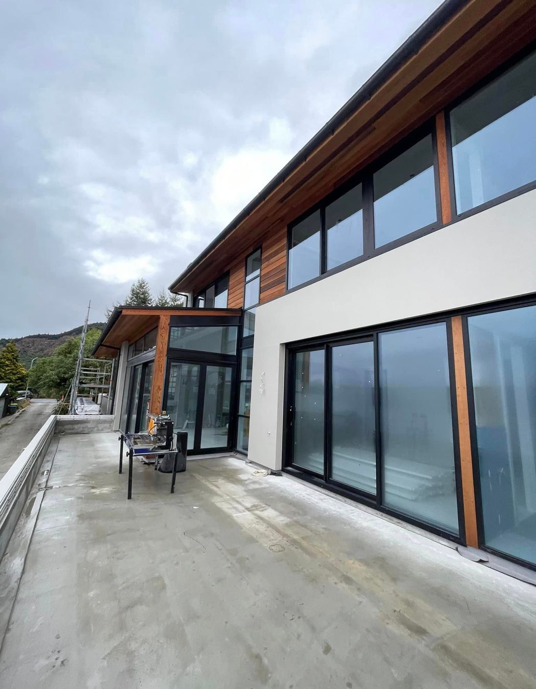 Cladding complete, cedar weatherboards and exterior plaster system in 'Resene - Quarter Arrowtown'