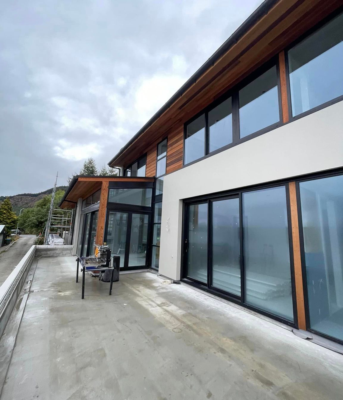 Cladding complete, cedar weatherboards and exterior plaster system in 'Resene - Quarter Arrowtown'