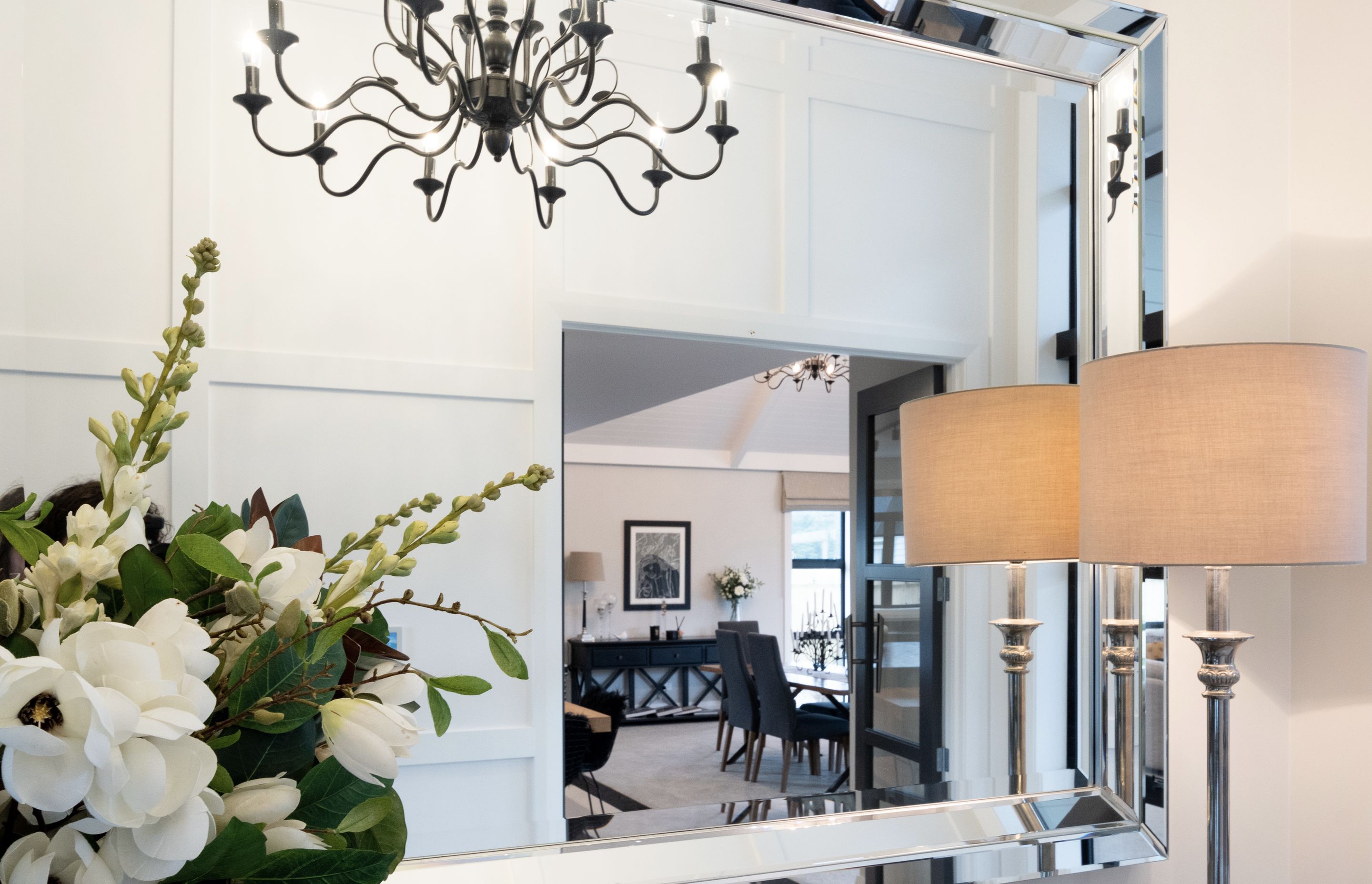 Opulent details such as chandeliers and mirrors elevate the interior spaces.