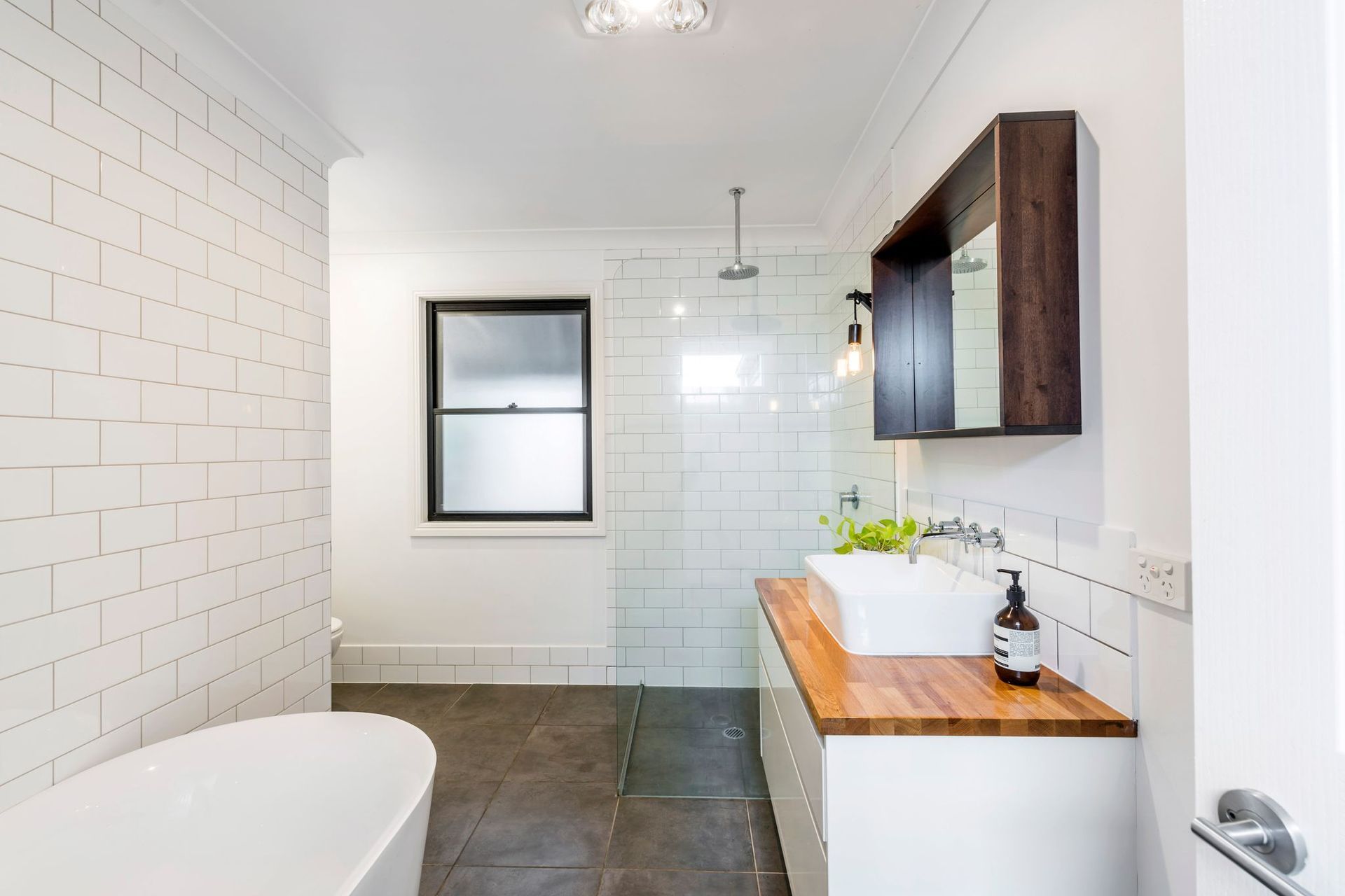 The bathroom is accessible and backs onto the laundry, with timber features bringing warmth to the space.