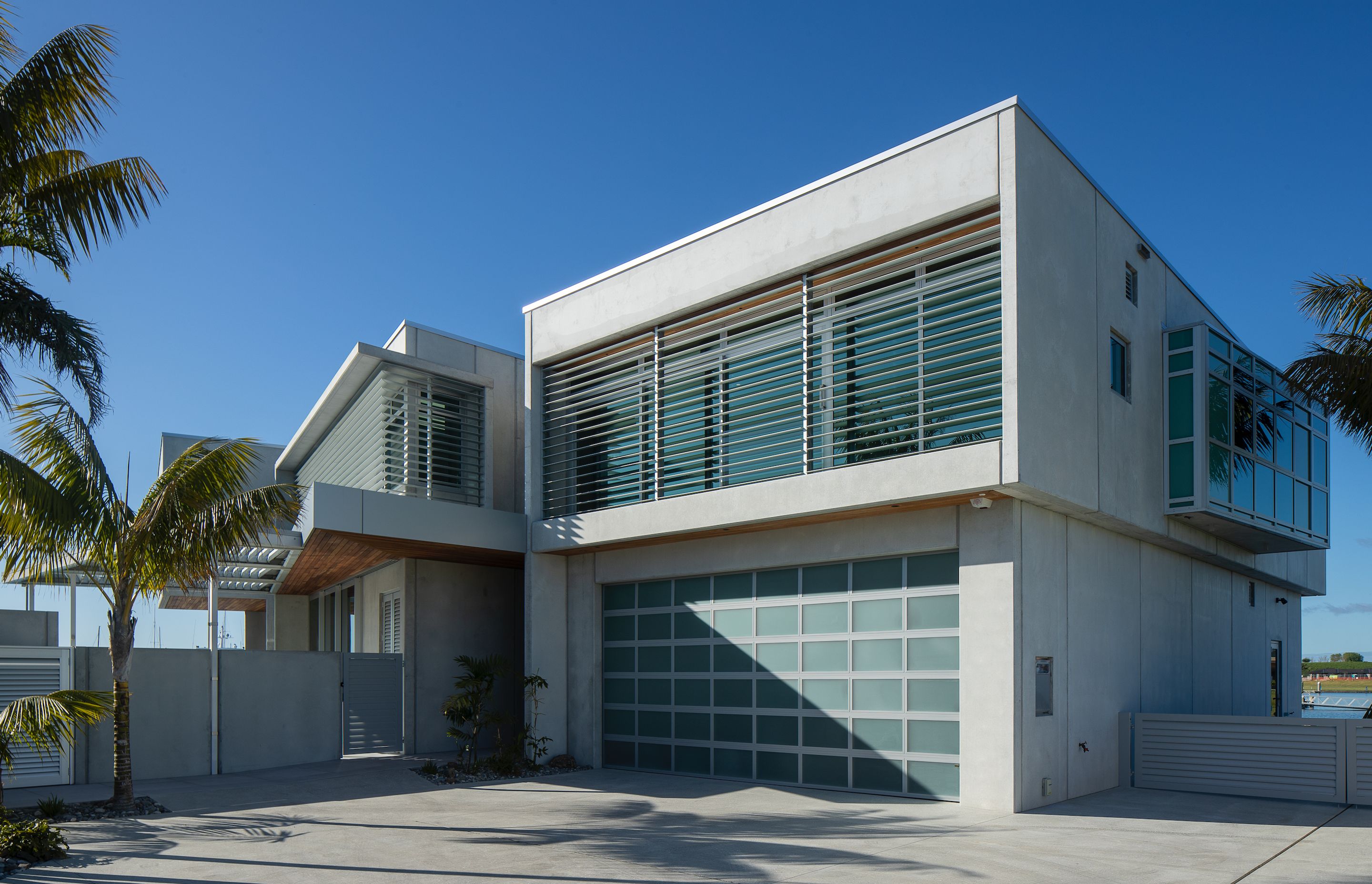 The building has a pared-back materiality of concrete, aluminium and stainless steel with accents of cedar.