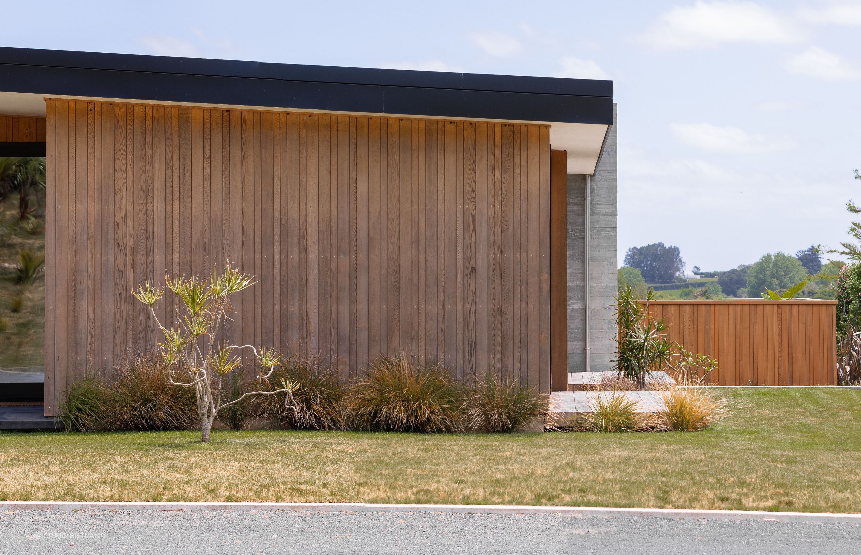 Random width vertical cedar weatherboards feature against the Insitu-concrete elements.