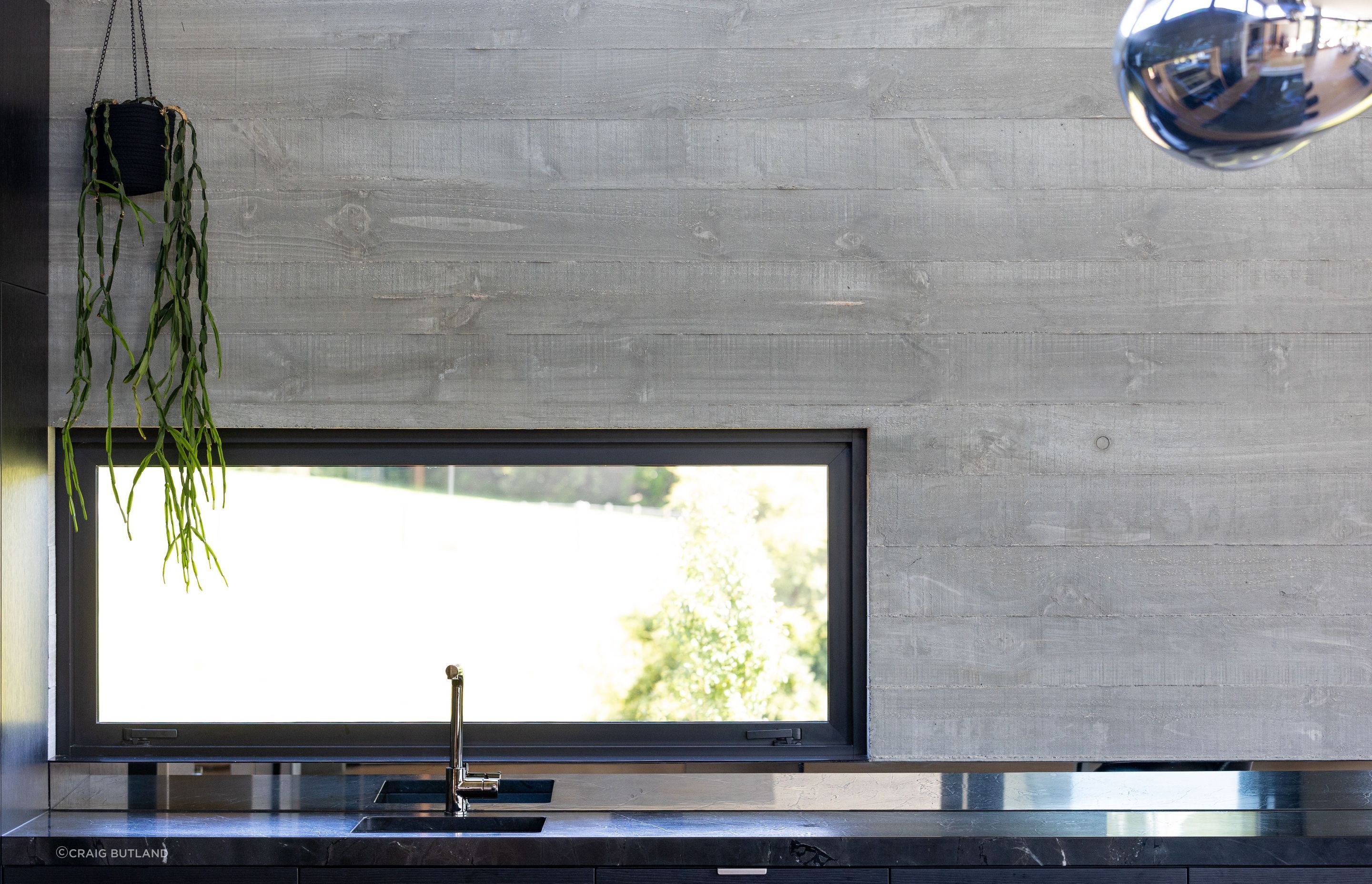 A lower outlook window in the kitchen frames the view to the exterior.