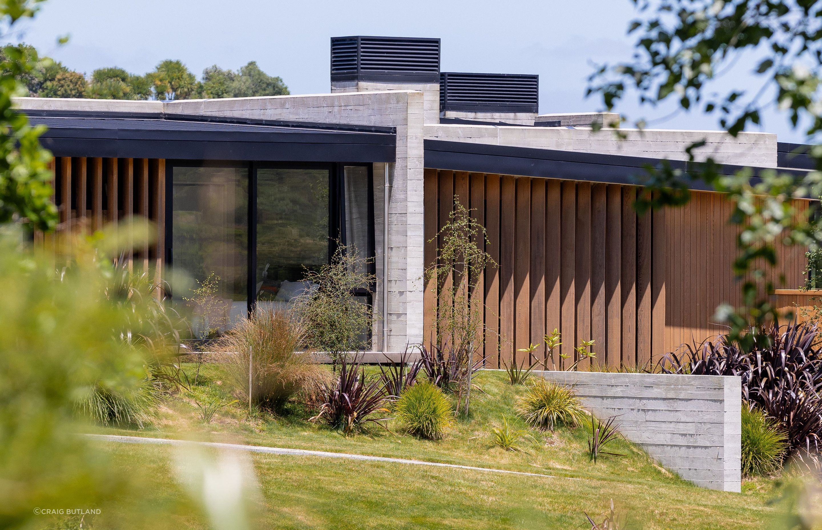 Insitu-concrete walls are broken with cedar fins and vertical cedar cladding.