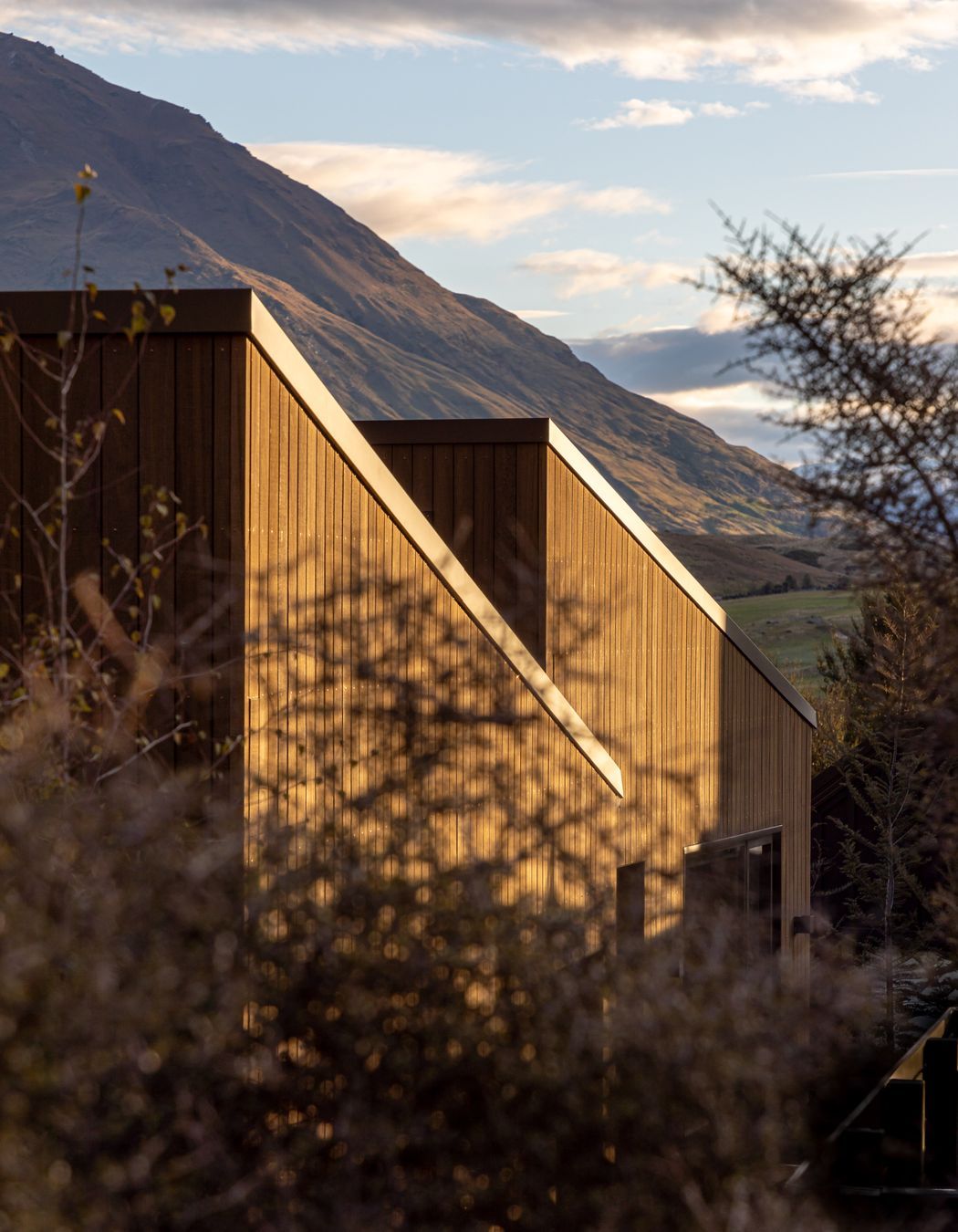 Single-pitch roof forms face the adjacent mountain range