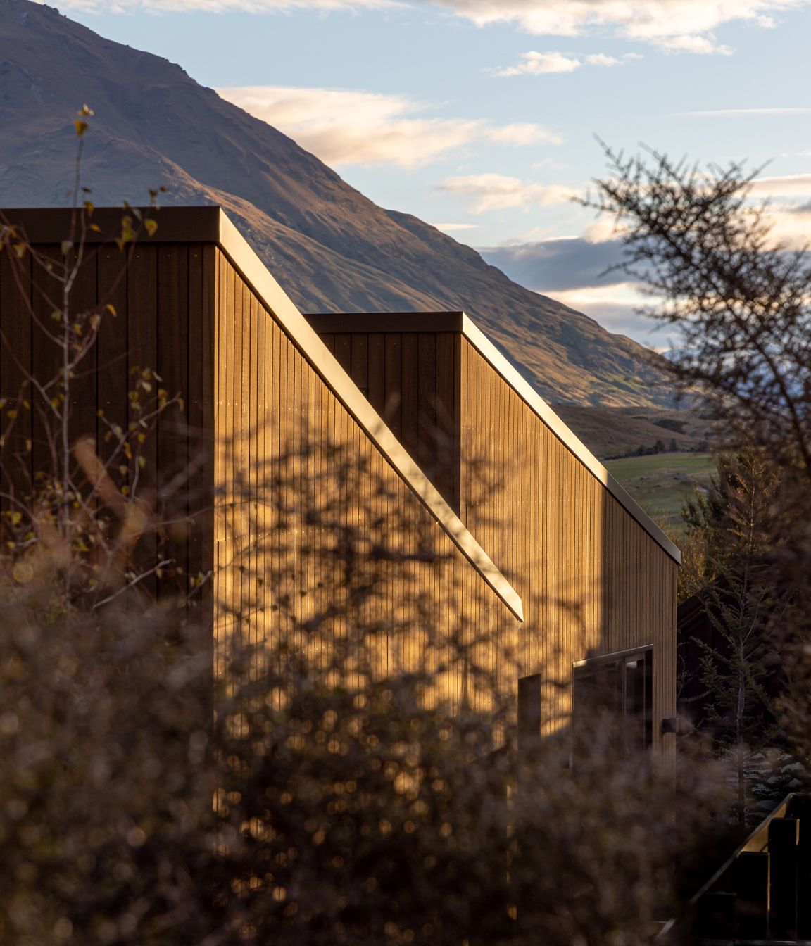Single-pitch roof forms face the adjacent mountain range