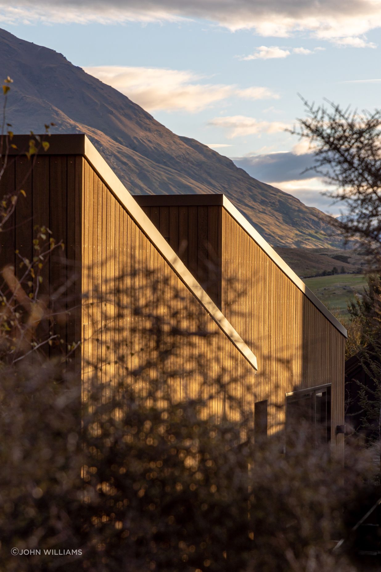 Single-pitch roof forms face the adjacent mountain range