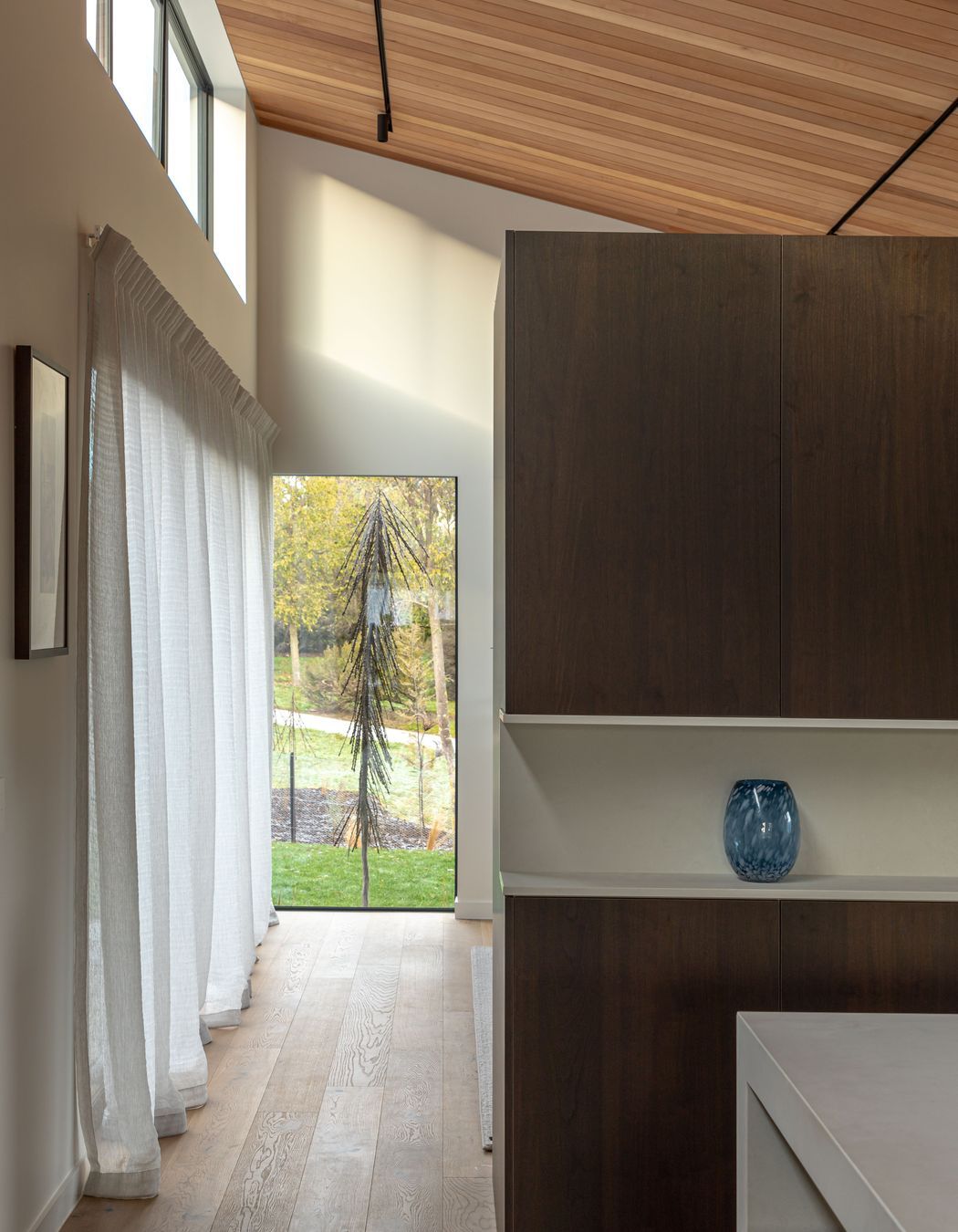 A wall of joinery separates the living and kitchen areas