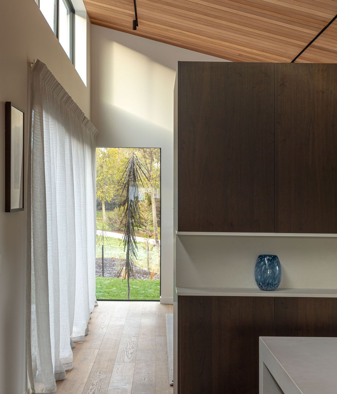 A wall of joinery separates the living and kitchen areas