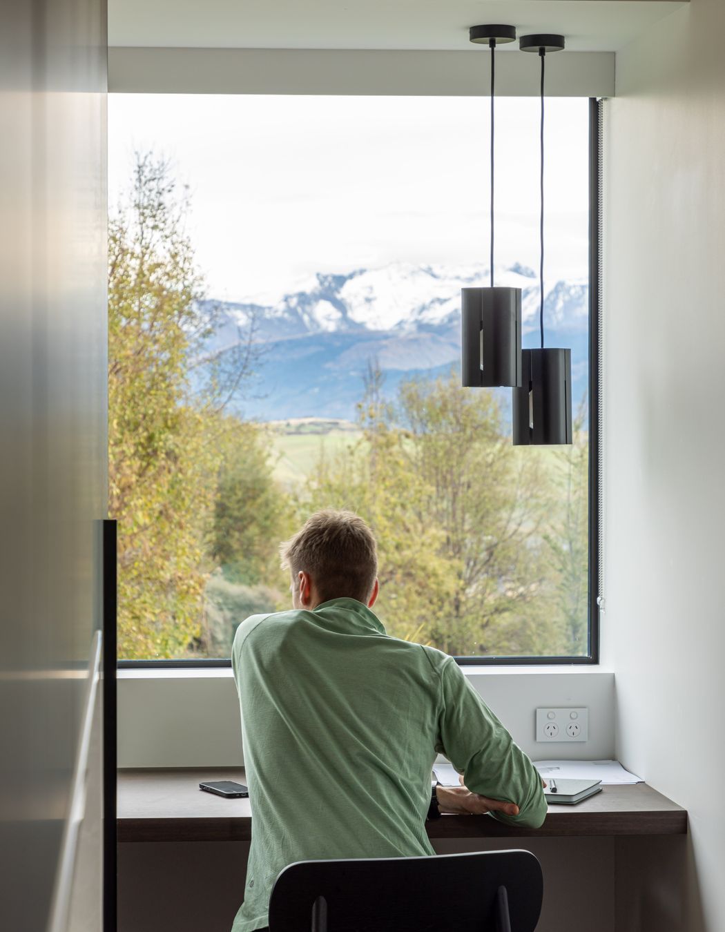 A private study nook off the main living space offers a focused space for work or study