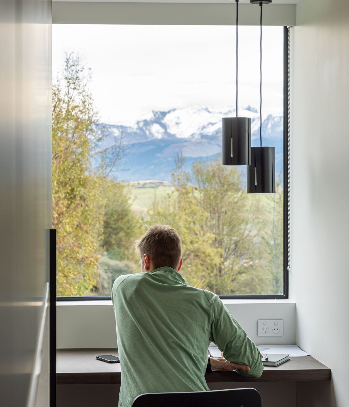 A private study nook off the main living space offers a focused space for work or study