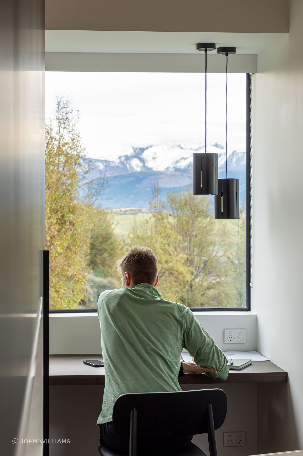 A private study nook off the main living space offers a focused space for work or study