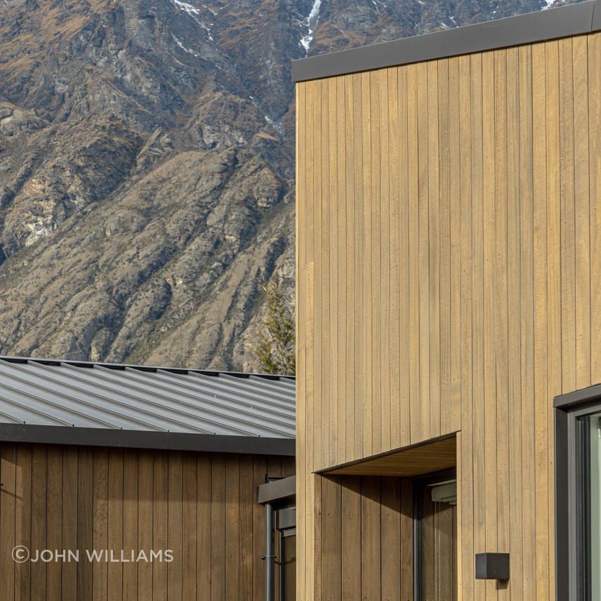 The earthy tones of this home sit comfortably against the rugged mountain backdrop