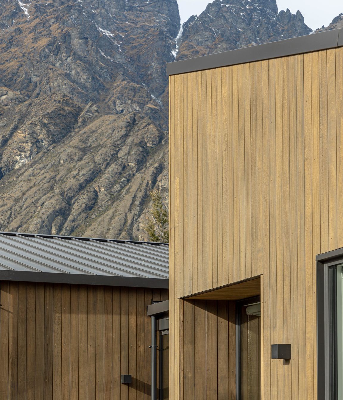 The earthy tones of this home sit comfortably against the rugged mountain backdrop
