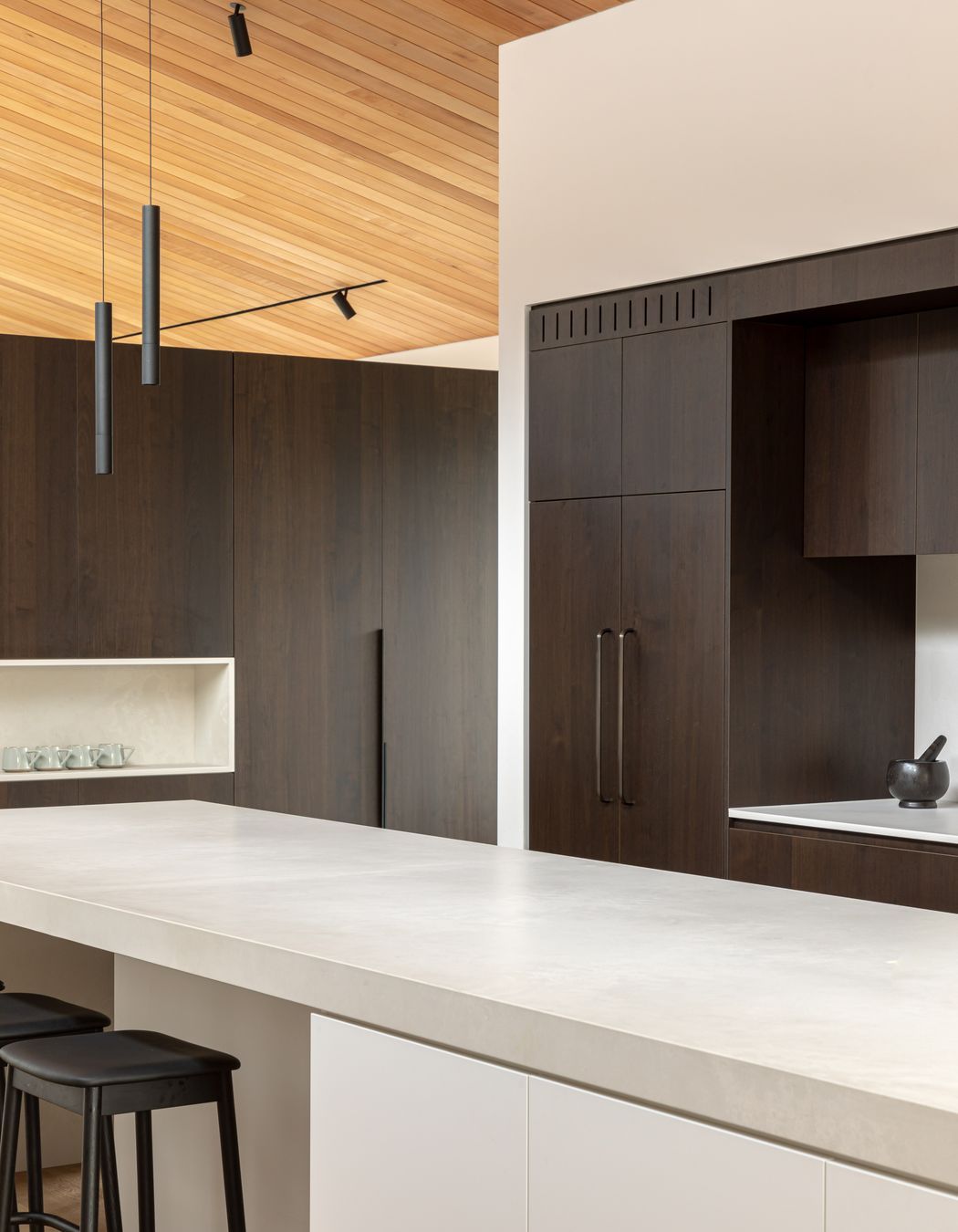 A generous, uncluttered island bench forms the kitchen's hub