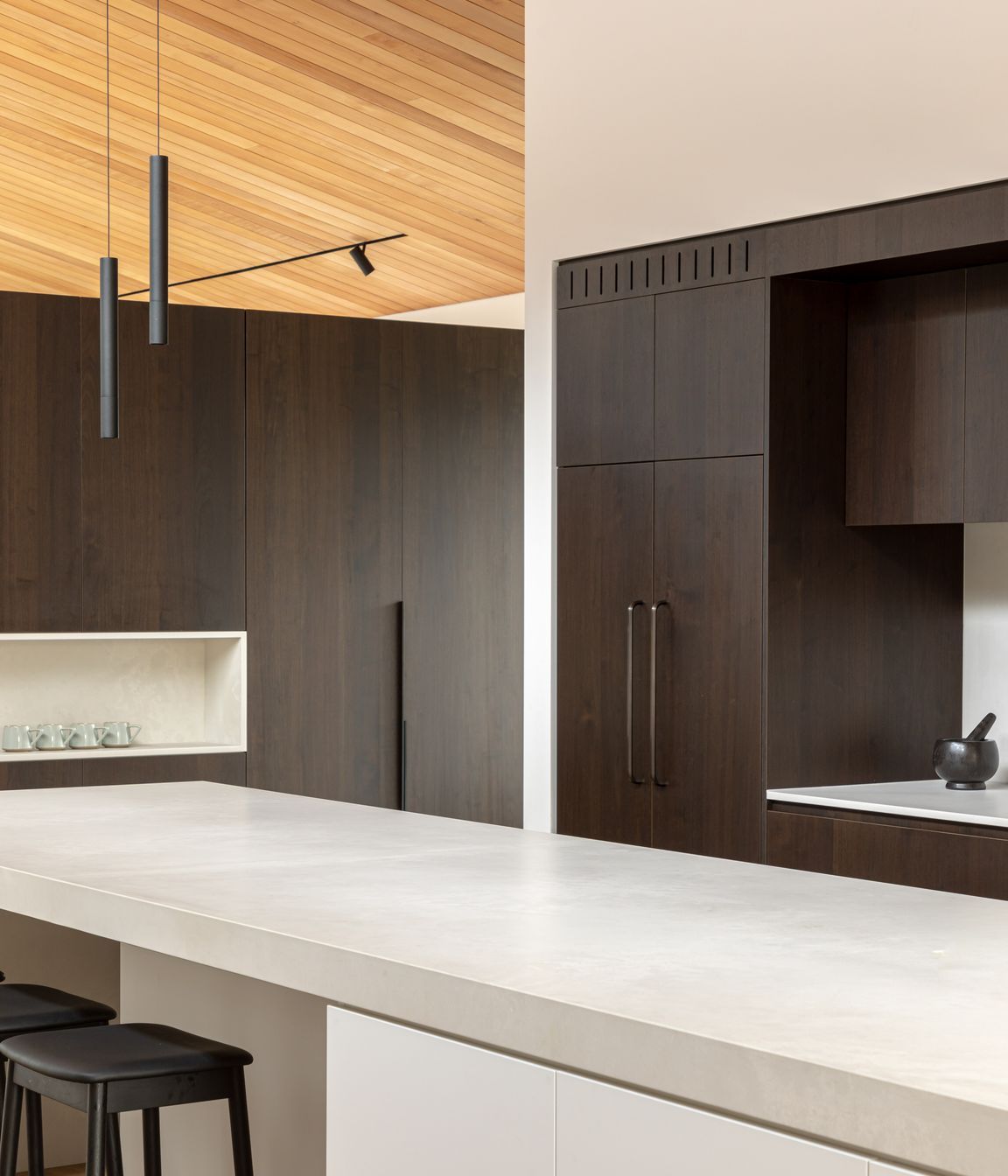 A generous, uncluttered island bench forms the kitchen's hub