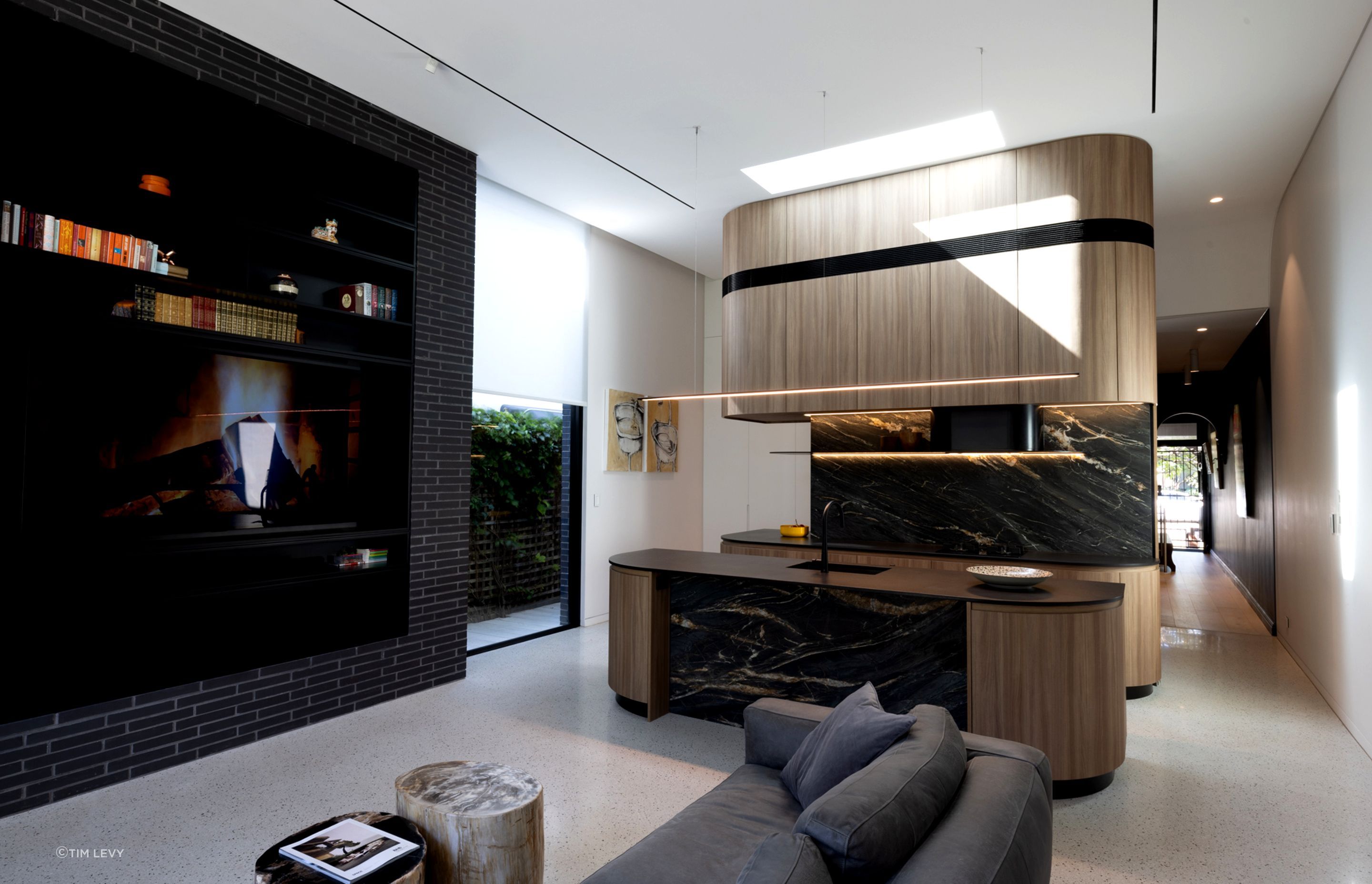 Kitchen and Black brick wall forming key elements of the new extension. A black hallway leads into the original part of the house